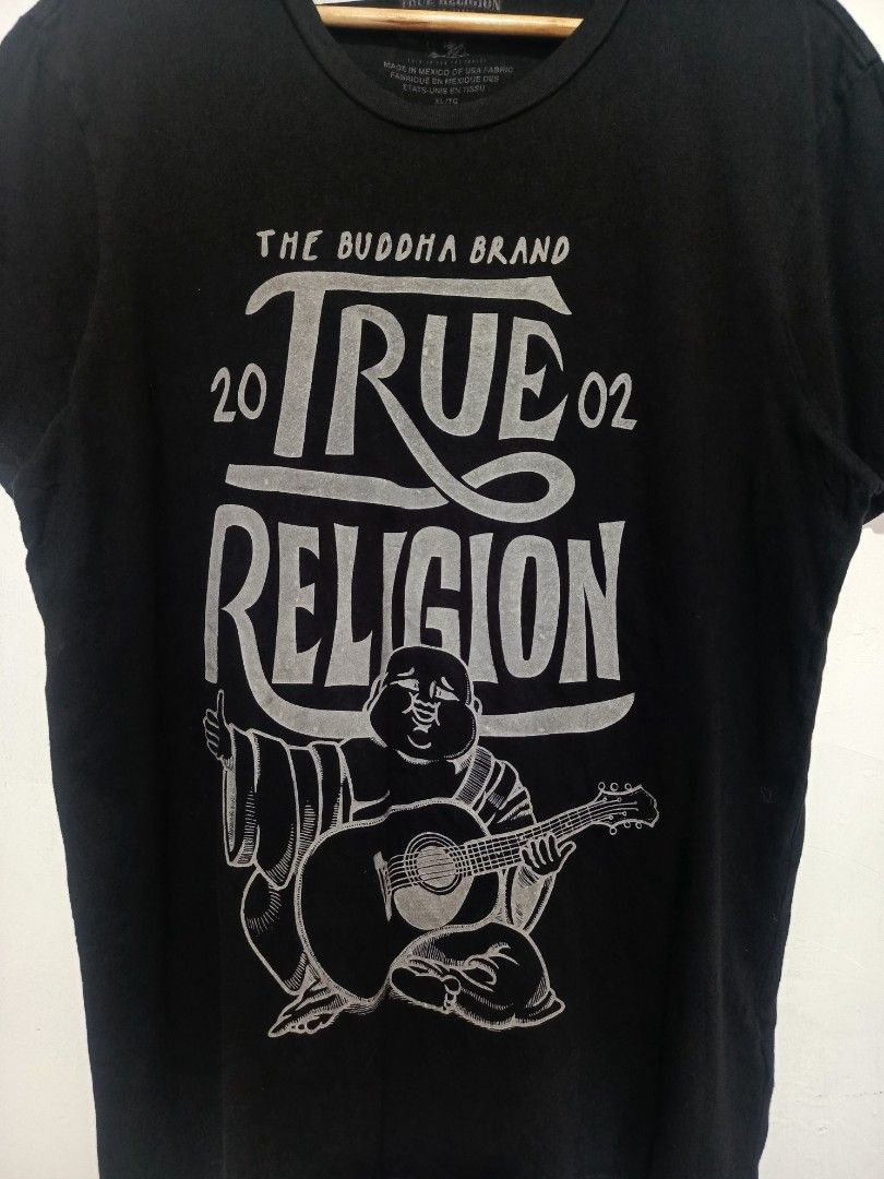 TRUE RELIGION SHIRT (Category: Tshirts & Polo Shirts ) located in Baguio. Submitted by 074thriftmania (Listing ID 1468602569, Image 3). Description: - Brand: True Religion - Style: Upfront Buddha crew neck tee - Color: Black - Size: Extra Large (XL) - Design: Silver print front graphic featuring Buddha, guitar artwork, and '20/'02 lettering - Authenticity: Printed neck label and interior wash tag intact - Origin: Made in Mexico of USA fabric leng