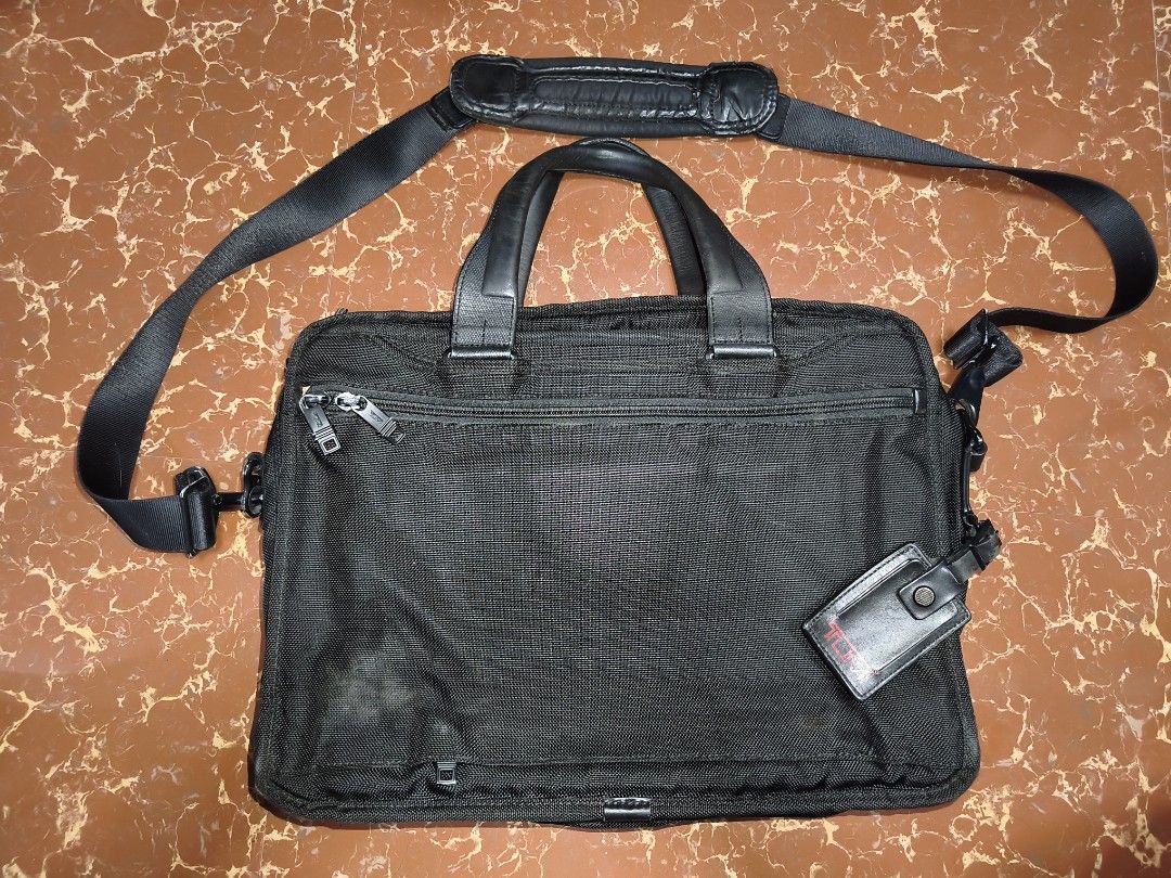 TUMI Alpha 2 Business Briefcase 26141D2 Black (Category: Briefcases) located in Bulacan. Submitted by THA_D_THRIFT (Listing ID 1468527028, Image 2). Description: - Brand/Model: TUMI Alpha 2 Laptop Briefcase (Model 26141D2) - Color/Material: Black FXT Ballistic Nylon with metal branding - Inclusions: Detachable shoulder strap, top handles, and registered TUMI Tracer tag - Features: Multiple zippered compartments, padded laptop section, and smart o