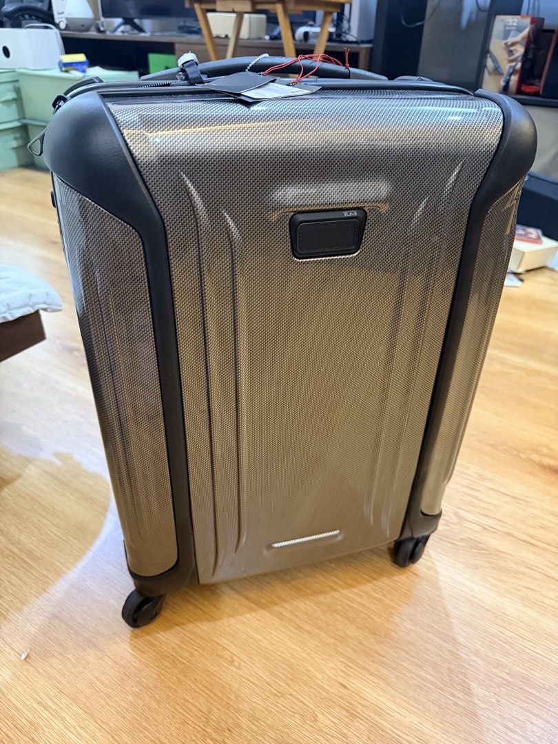 TUMI Luggage Suitcase (Category: Luggage) located in Manila. Submitted by jylesang (Listing ID 1468503300, Image 3). Description: - Brand new with tags attached - Premium TUMI hardside suitcase in a sleek textured grey finish with dark trim - Smooth spinner wheels for effortless mobility - Sturdy telescoping handle and convenient retractable top handle - Large vertical debossed TUMI logo on the rear shell.