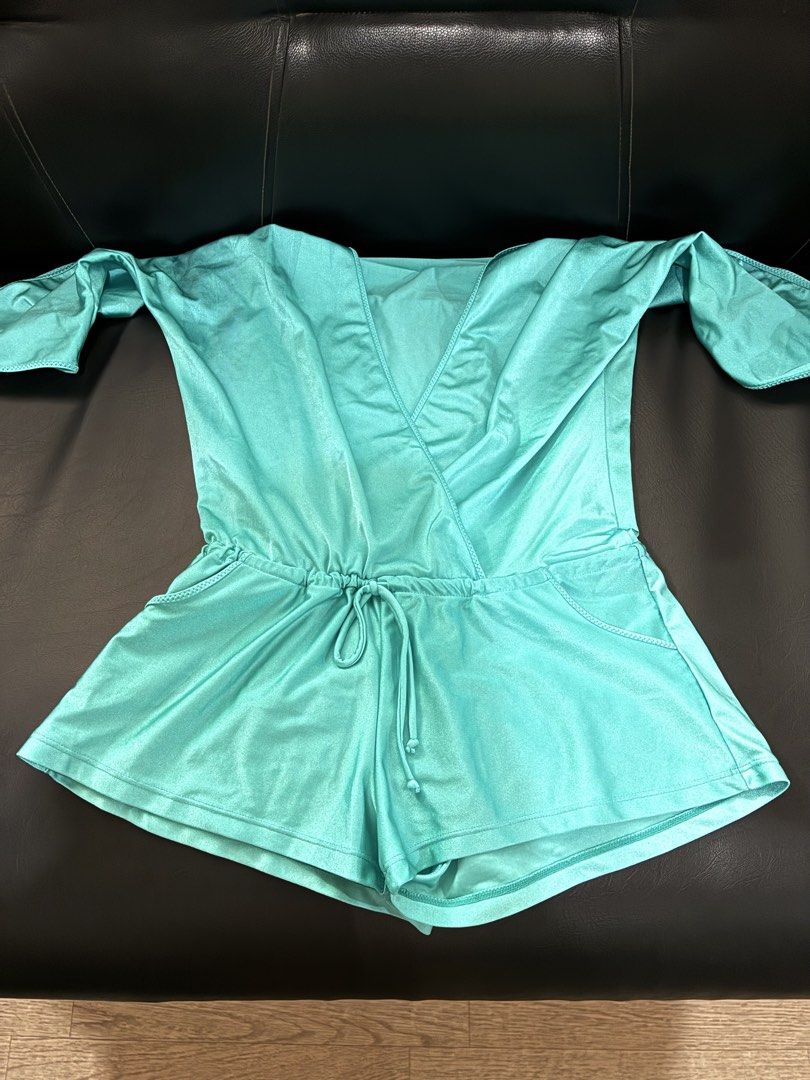 Turquoise DeepV-Neck Romper with Bow Sleeves (Category: Rompers) located in Tanauan. Submitted by theitgirlsdibs4 (Listing ID 1468711531, Image 3). Description: - Color: Turquoise - Style: Plunging V-neck romper with half sleeves and cute tie bows - Waist: Comfortable elastic waistband with matching drawstring - Material: Smooth, lightweight fabric with a subtle sheen - Features: Functional front hip pockets - Best for: Warm weather, vacations, o