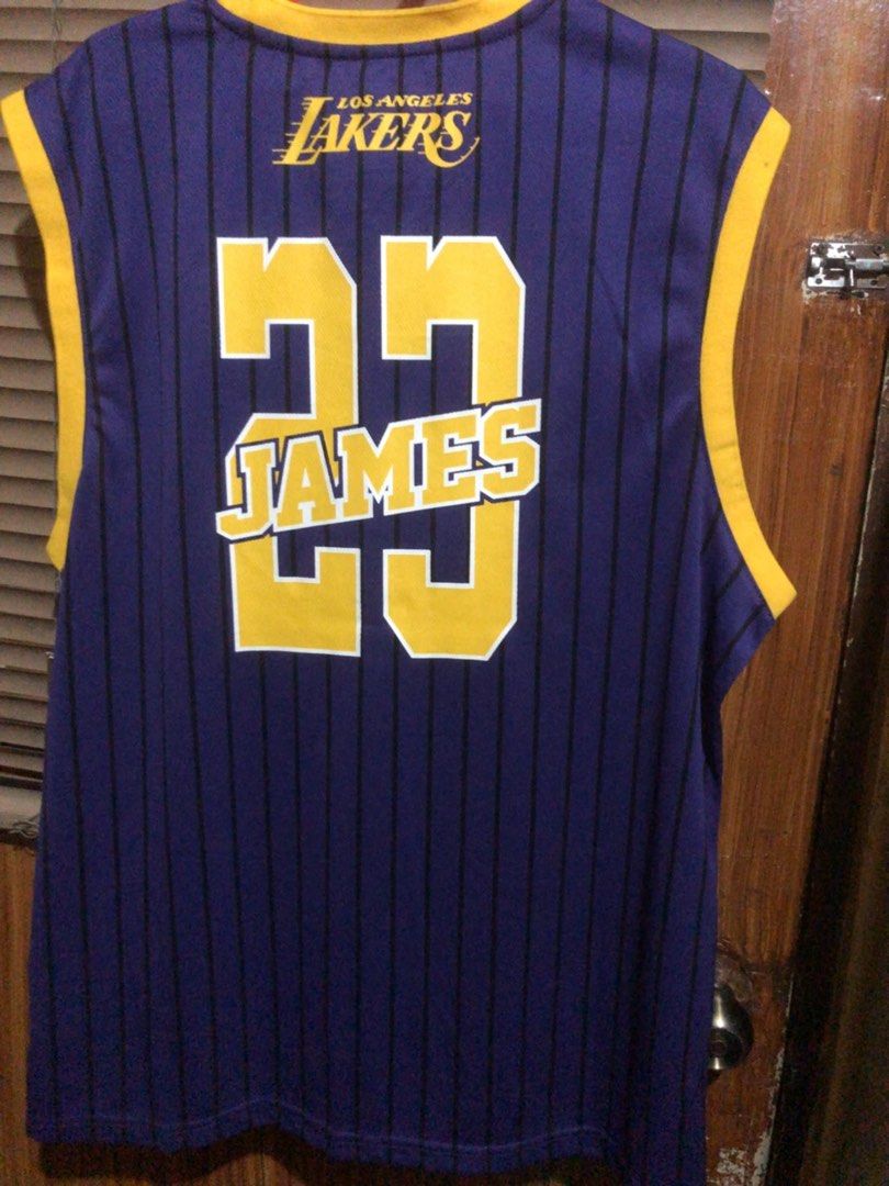 ULTRA GAME NBA OFFICIAL (Category: Activewear) located in Muntinlupa City. Submitted by ybmcloset2230 (Listing ID 1468597070, Image 2). Description: • Brand: Ultra Game • Official NBA Licensed Apparel • Player: LeBron James #23 • Los Angeles Lakers • Details: Gold embroidered number, official Lakers side patch, original tag attached • Condition: Brand new with tags .