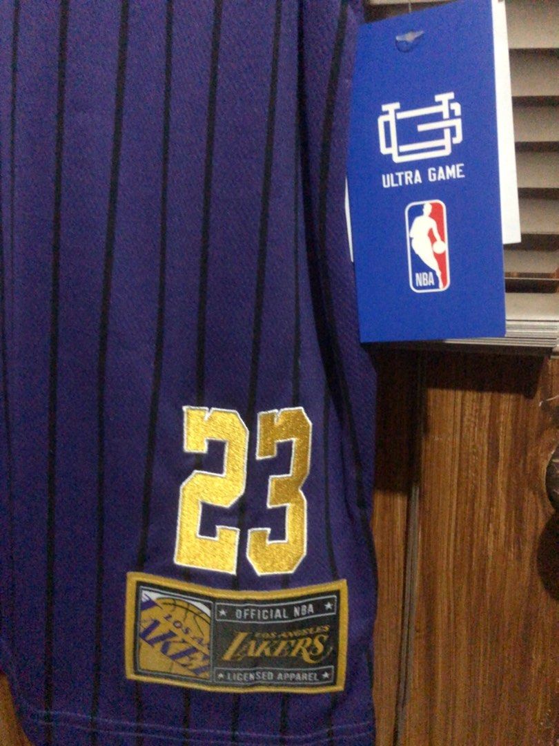 ULTRA GAME NBA OFFICIAL (Category: Activewear) located in Muntinlupa City. Submitted by ybmcloset2230 (Listing ID 1468597070, Image 3). Description: • Brand: Ultra Game • Official NBA Licensed Apparel • Player: LeBron James #23 • Los Angeles Lakers • Details: Gold embroidered number, official Lakers side patch, original tag attached • Condition: Brand new with tags .