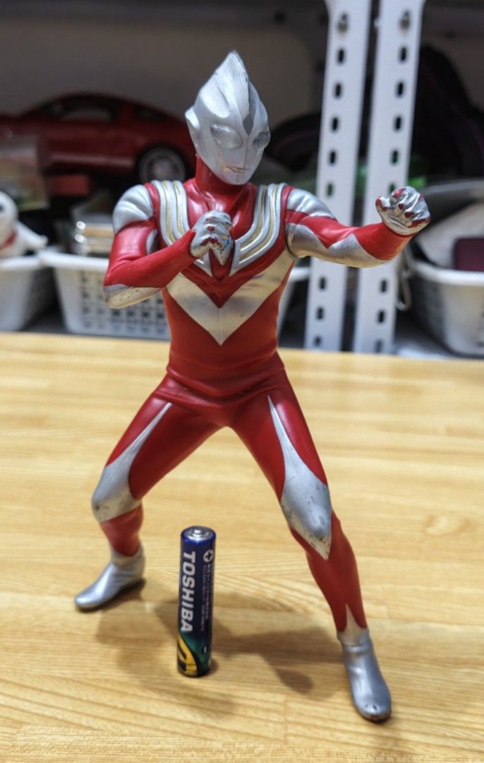 Ultraman Action Figures Bundle Set (Category: Figurines & Statues) located in San Pedro. Submitted by toydibz (Listing ID 1468534514, Image 3). Description: - Assorted Ultraman vinyl figures in different sizes and poses - Includes classic red/silver designs and newer forms with blue/dark armor - AA battery included in photos to show scale - Condition: Has minor paint scuffs and wear marks from past play - Great bundle for fans and collectors - Mo