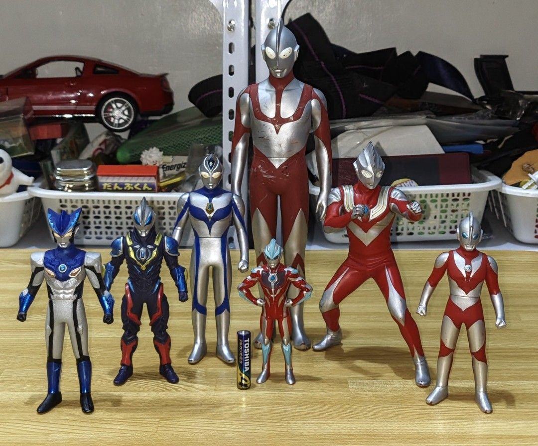 Ultraman Action Figures Bundle Set (Category: Figurines & Statues) located in San Pedro. Submitted by toydibz (Listing ID 1468534514, Image 1). Description: - Assorted Ultraman vinyl figures in different sizes and poses - Includes classic red/silver designs and newer forms with blue/dark armor - AA battery included in photos to show scale - Condition: Has minor paint scuffs and wear marks from past play - Great bundle for fans and collectors - Mo