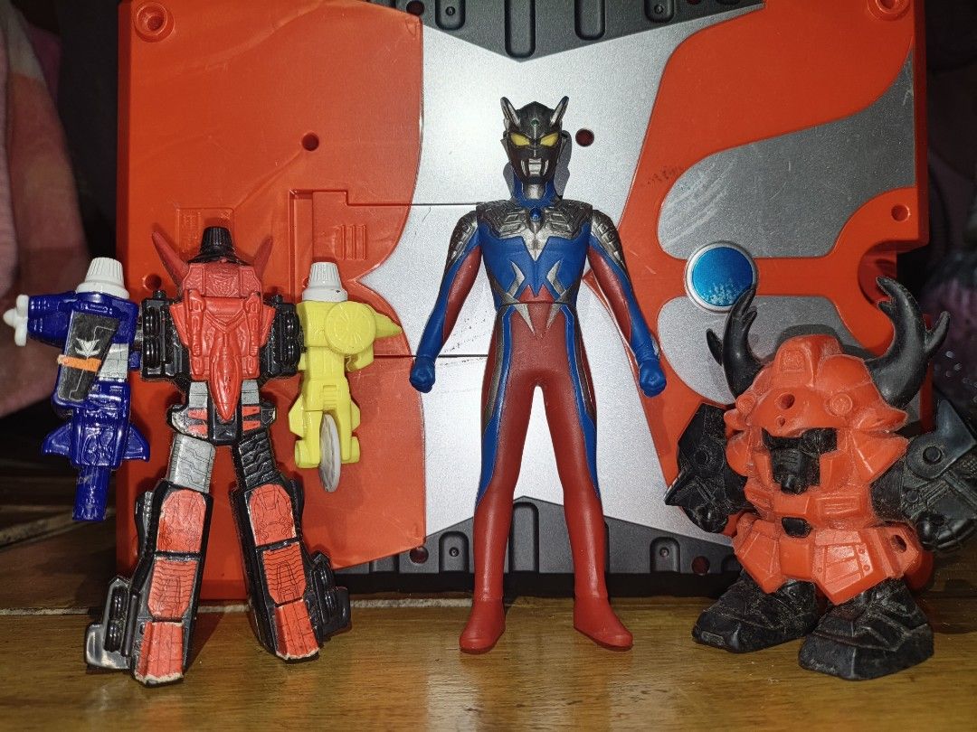 Ultraman and Robot Action Figures Bundle (Category: Figurines & Statues) located in Daanbantayan. Submitted by mvs08_collectibles (Listing ID 1468659213, Image 1). Description: - Bundle of 3 action figures for collectors - Includes an Ultraman figure (blue, red, and silver) - Includes a mecha robot with 2018 McDonald's stamping (black, red, and blue) - Includes a horned action figure (red and black) - Condition: Shows minor surface wear and dust 