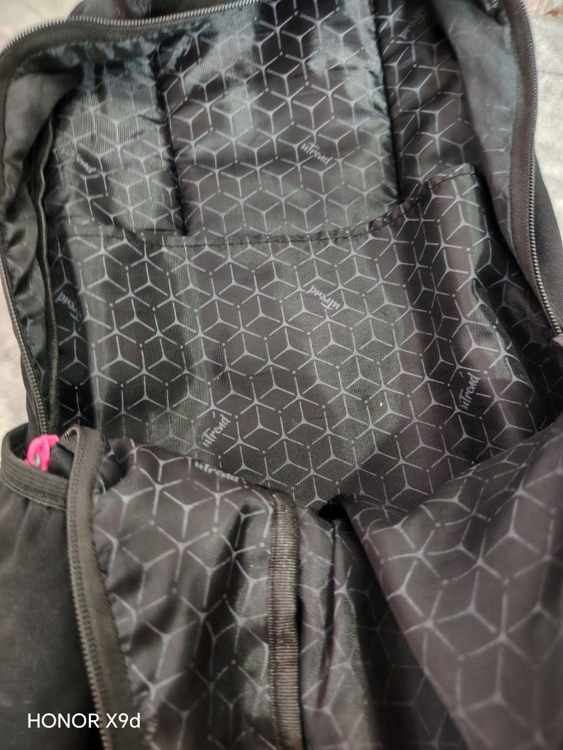 Ultrend Black Backpack with Pink Zippers (Category: Backpacks) located in Mabalacat. Submitted by Jackikay.PreLoved (Listing ID 1468504424, Image 3). Description: Sleek black Ultrend backpack featuring eye-catching pink zippers and front patch logo. Built from durable canvas with multiple zippered compartments, a patterned inner lining, and smooth, adjustable straps. Perfect for school, work, or casual trips. some flaw or stains. .
