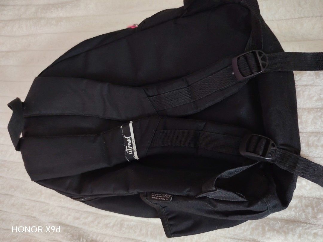 Ultrend Black Backpack with Pink Zippers (Category: Backpacks) located in Mabalacat. Submitted by Jackikay.PreLoved (Listing ID 1468504424, Image 2). Description: Sleek black Ultrend backpack featuring eye-catching pink zippers and front patch logo. Built from durable canvas with multiple zippered compartments, a patterned inner lining, and smooth, adjustable straps. Perfect for school, work, or casual trips. some flaw or stains. .