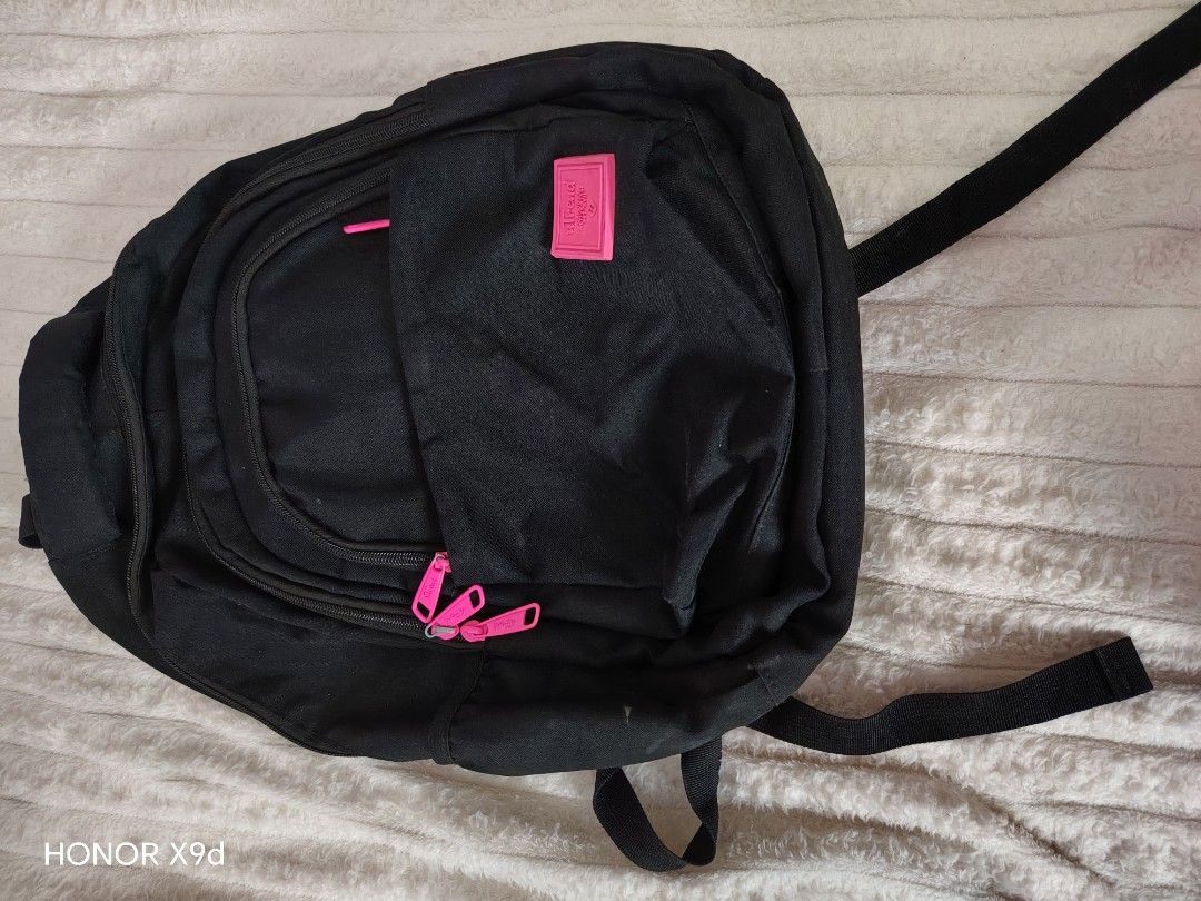 Ultrend Black Backpack with Pink Zippers (Category: Backpacks) located in Mabalacat. Submitted by Jackikay.PreLoved (Listing ID 1468504424, Image 1). Description: Sleek black Ultrend backpack featuring eye-catching pink zippers and front patch logo. Built from durable canvas with multiple zippered compartments, a patterned inner lining, and smooth, adjustable straps. Perfect for school, work, or casual trips. some flaw or stains. .