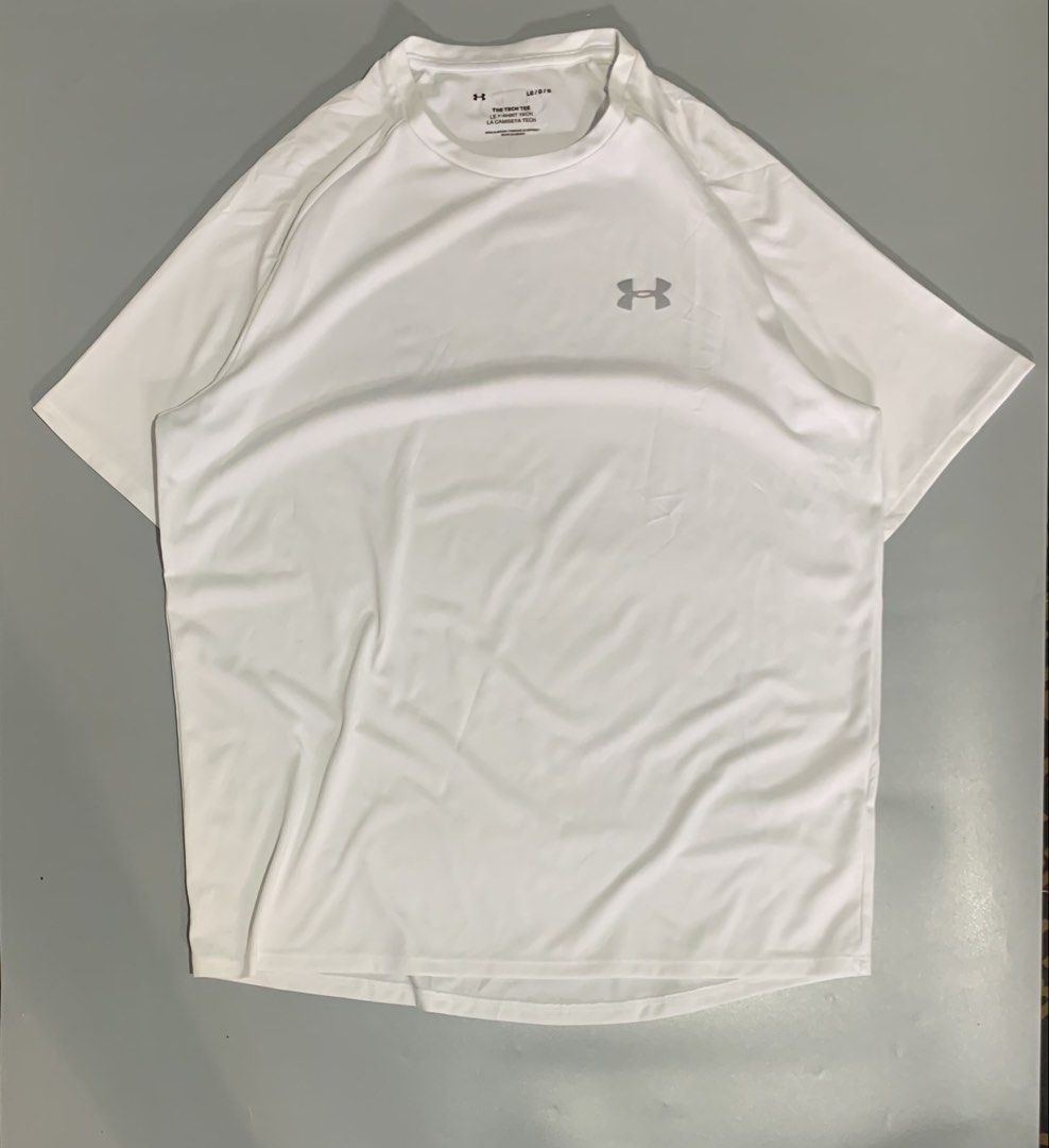 Under Armour The Tech Tee White (Category: Tshirts & Polo Shirts ) located in Cebu City. Submitted by stuff_paid (Listing ID 1468639955, Image 1). Description: - Brand: Under Armour - Item: The Tech Tee - Color: White - Size: Large (L) - Condition: Excellent / Pre-loved (as applicable) - Material: Lightweight, breathable athletic fabric - Details: Short sleeves, silver logo on chest and back collar, interior QR code tag - Style: Clean, plain desi