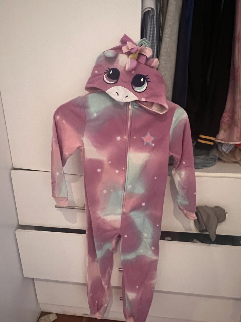 Unicorn Hooded Onesie Pyjamas (Category: Babies & Kids Fashion) located in Manila. Submitted by asecondstory (Listing ID 1468502003, Image 1). Description: - Super soft fleece fabric for ultimate comfort - Dreamy pink, purple, and mint tie-dye with white star pattern - Attached 3D hood with embroidered unicorn eyes, horn, mane, and ears - Cute pink star applique on the chest - Easy front full zipper closure - Ribbed cuffs at wrists and ankles to 