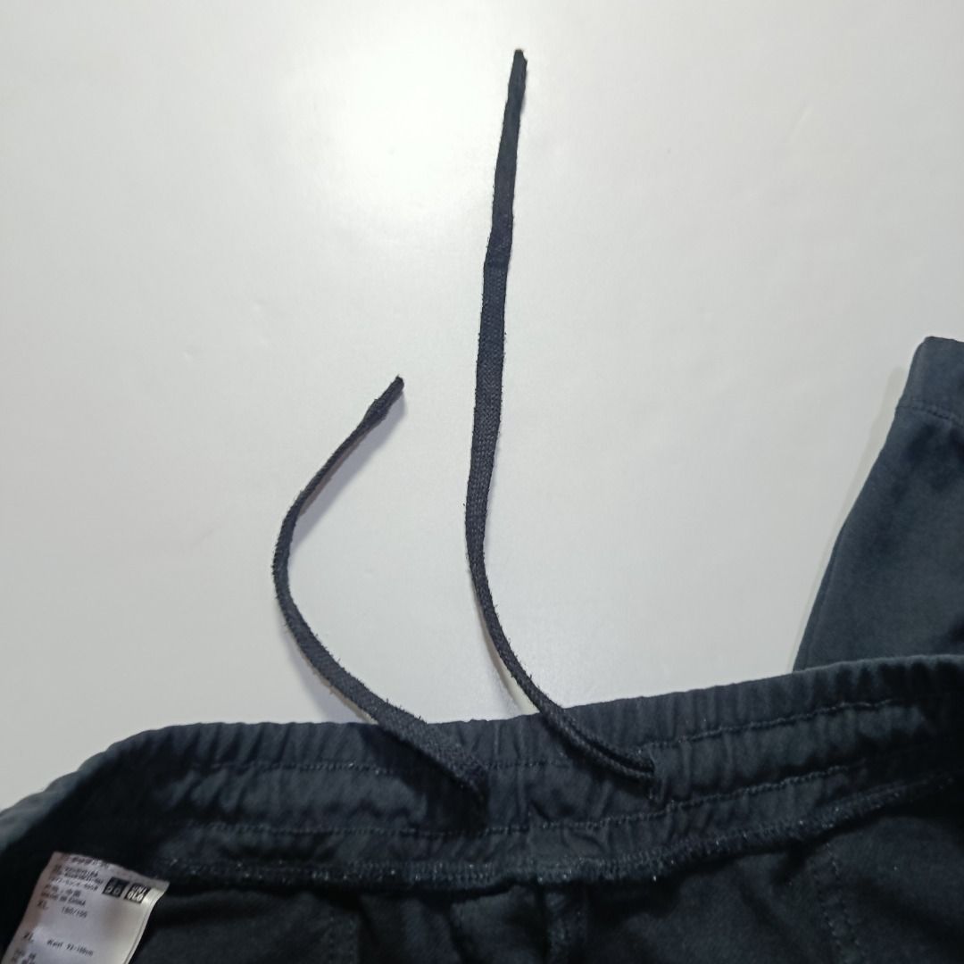 UNIQLO Black Sweat Jogger Pants (Category: Joggers) located in Taytay. Submitted by hoodgrail.vtg (Listing ID 1468604128, Image 3). Description: • Excellent condition - Lightly used • Minimalist black design with elastic waistband and ankle cuffs • Size on tag: XL — best fits 34-38 • Measurements: 17 x 40 in • Leg opening: 5.5 in (elastic) • Color rate: 9/10 • Issue: None.