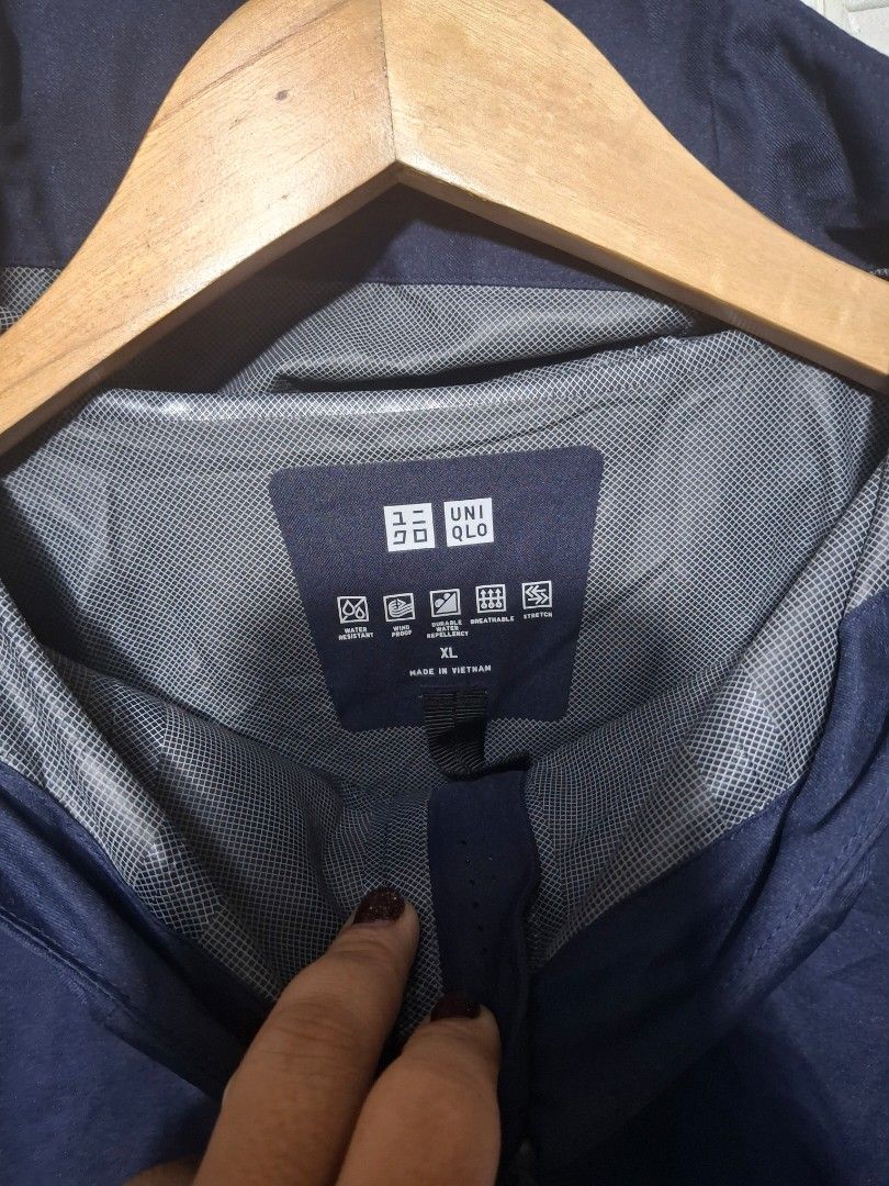 Uniqlo Blocktech Parka for Men (Category: Coats, Jackets and Outerwear) located in Angeles City. Submitted by livemountain.e2ae07 (Listing ID 1468521996, Image 2). Description: - Brand: Uniqlo - Item: Windproof & Waterproof Parka - Color: Dark Navy Blue - Size: XL - W23.4 L29.4 - Material: 100% Polyester (Made in Vietnam) - Features: Grid pattern interior lining, taped zippers, and attached hood - Condition: Clean inside and out, ready to wear - 