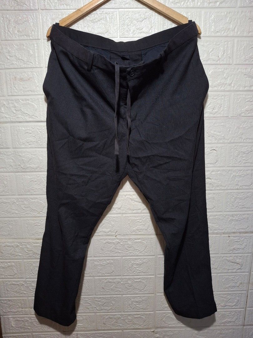 Uniqlo Checked Drawstring Trousers XL (Category: Trousers) located in Angeles City. Submitted by livemountain.e2ae07 (Listing ID 1468547152, Image 1). Description: - Brand: Uniqlo - Color: Navy blue with classic check pattern - Size: XL (fits 92-100cm waist) - W18 L36 HEM 7.6 - Material: Lightweight blend of polyester, rayon, and polyurethane - Waistband: Elastic with adjustable drawstring - Closure: Button fly - Pockets: Two back pockets with bu