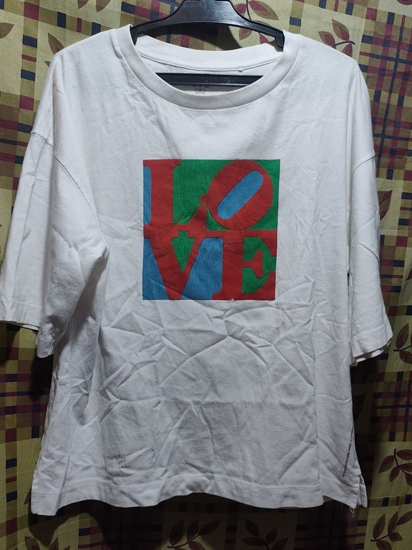 UNIQLO LOVE PRINT (Category: Shirts) located in Bauang. Submitted by chrisquinto2004 (Listing ID 1468523907, Image 1). Description: - Brand: Uniqlo UT (Text Messages Collection) - Design: Iconic Pop Art "LOVE" graphic print in red, green, and blue - Color: White - Size: Medium (Bust: 80-86cm / Height: 160/84A) - Material: 100% Cotton - soft, breathable, and comfortable - Condition: Layered condition 8/10, well-maintained and ready to wear - Versa
