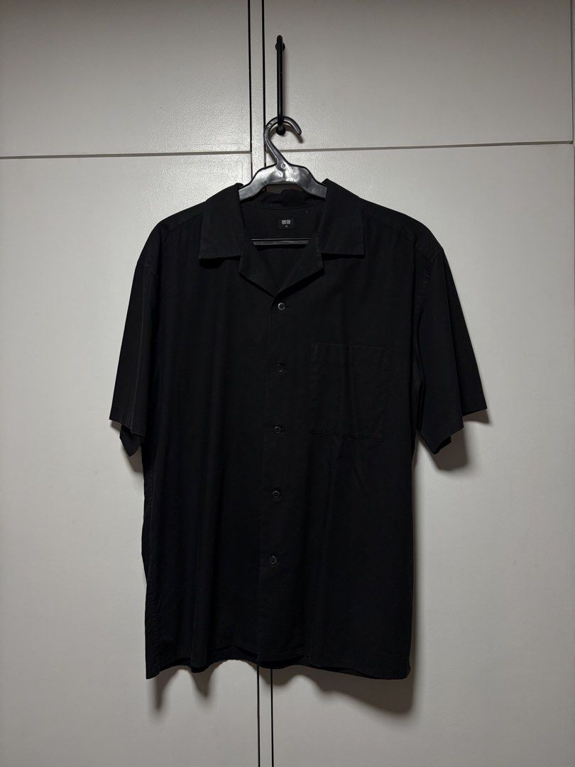 Uniqlo Open Collar Black Short Sleeve (Category: Tshirts & Polo Shirts ) located in San Fernando. Submitted by uniquegallery.ph (Listing ID 1468501967, Image 1). Description: - Brand: Uniqlo - Item: Short Sleeve Camp Collar Button-Up Shirt - Color: Classic Black - Size: Medium (M) - Design: Open camp collar and single left chest pocket - Fabric: Lightweight and breathable - Versatile: Great to match with shorts or denim for an effortless casual o