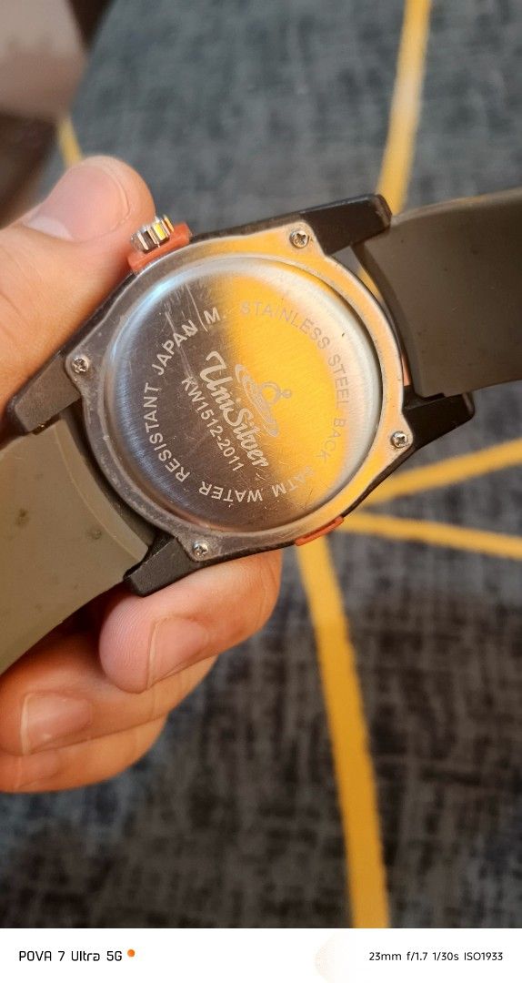 Unisilver watch (Category: Men's Watches) located in Quezon City. Submitted by junseller18 (Listing ID 1468554897, Image 3). Description: bago battery, - Brand: Unisilver orig - Model: KW1512-2011 - Design: Bold orange bezel with unique number dial and gray textured rubber strap - Movement & Build: Japan Movement, Stainless Steel Back - Water Resistance: 5 ATM Water Resistant - Condition: 7/10 (pre-loved, well-kept with minor signs of wear) - Per