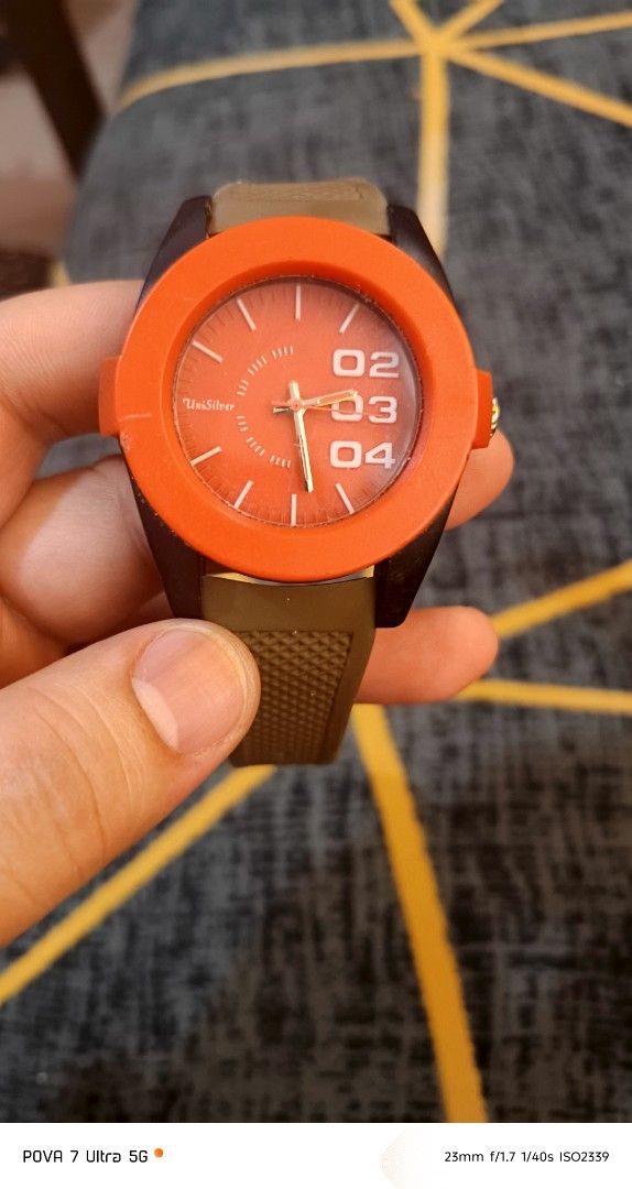 Unisilver watch (Category: Men's Watches) located in Quezon City. Submitted by junseller18 (Listing ID 1468554897, Image 1). Description: bago battery, - Brand: Unisilver orig - Model: KW1512-2011 - Design: Bold orange bezel with unique number dial and gray textured rubber strap - Movement & Build: Japan Movement, Stainless Steel Back - Water Resistance: 5 ATM Water Resistant - Condition: 7/10 (pre-loved, well-kept with minor signs of wear) - Per