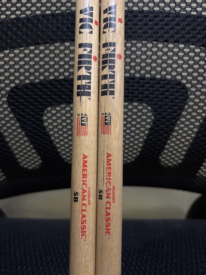 Vic Firth American Classic 5B Drumsticks (Category: Musical Instruments) located in Malabon City. Submitted by luxgoals (Listing ID 1468522014, Image 2). Description: - Brand/Model: Vic Firth 5B - Material: Genuine Hickory with standard wooden tips - Condition: Used, with minor stick marks; logos and size markings still clearly visible - Feel: Standard weight and balance - Best For: General drumming practice and band rehearsals - Meet-ups or ship