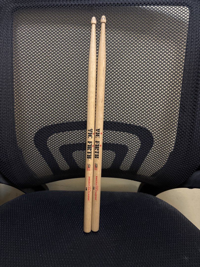 Vic Firth American Classic 5B Drumsticks (Category: Musical Instruments) located in Malabon City. Submitted by luxgoals (Listing ID 1468522014, Image 1). Description: - Brand/Model: Vic Firth 5B - Material: Genuine Hickory with standard wooden tips - Condition: Used, with minor stick marks; logos and size markings still clearly visible - Feel: Standard weight and balance - Best For: General drumming practice and band rehearsals - Meet-ups or ship