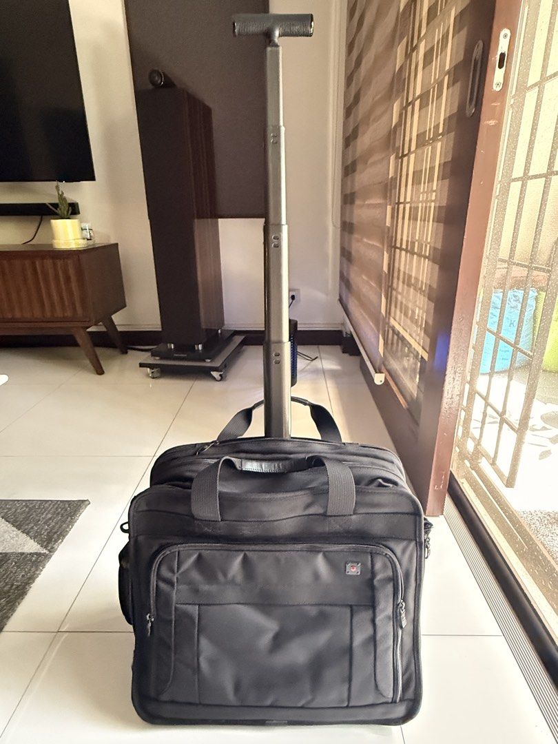 Victorinox Rolling Laptop Briefcase (Category: Briefcases) located in Pasig City. Submitted by boohberry (Listing ID 1468547955, Image 2). Description: - Brand: Victorinox - Material: Durable black nylon - Mobility: Retractable handle, sturdy top handles, and smooth-rolling wheels - Storage: Multiple zippered compartments with an internal organizer panel - Laptop Protection: Padded laptop sleeve with secure strap - Extras: Includes a detachable s