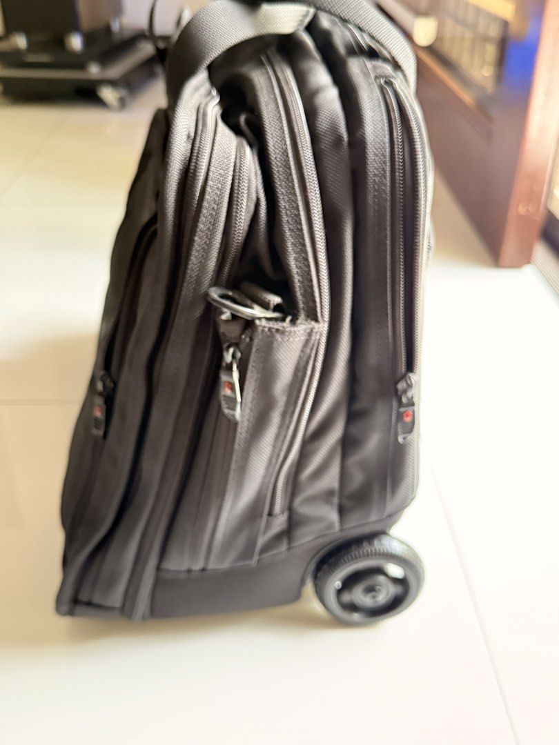 Victorinox Rolling Laptop Briefcase (Category: Briefcases) located in Pasig City. Submitted by boohberry (Listing ID 1468547955, Image 3). Description: - Brand: Victorinox - Material: Durable black nylon - Mobility: Retractable handle, sturdy top handles, and smooth-rolling wheels - Storage: Multiple zippered compartments with an internal organizer panel - Laptop Protection: Padded laptop sleeve with secure strap - Extras: Includes a detachable s