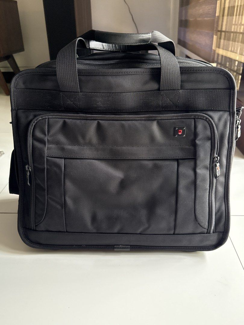 Victorinox Rolling Laptop Briefcase (Category: Briefcases) located in Pasig City. Submitted by boohberry (Listing ID 1468547955, Image 1). Description: - Brand: Victorinox - Material: Durable black nylon - Mobility: Retractable handle, sturdy top handles, and smooth-rolling wheels - Storage: Multiple zippered compartments with an internal organizer panel - Laptop Protection: Padded laptop sleeve with secure strap - Extras: Includes a detachable s