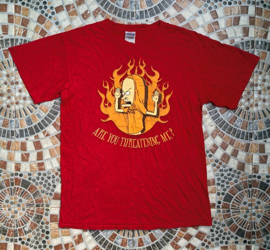 Vintage 2004 Beavis and Butt-Head Cornholio T-Shirt Medium (Category: Tshirts & Polo Shirts ) located in Quezon. Submitted by miksxthrift (Listing ID 1468616059, Image 1). Description: - Official 2004 Mike Judge merchandise - Features Beavis with a classic flame background - Iconic 'ARE YOU THREATENING ME' quote graphic - Gildan Heavy Cotton tag, size Medium - 100% preshrunk cotton, made in Haiti - Authentic vintage cartoon collectible Size:21x28