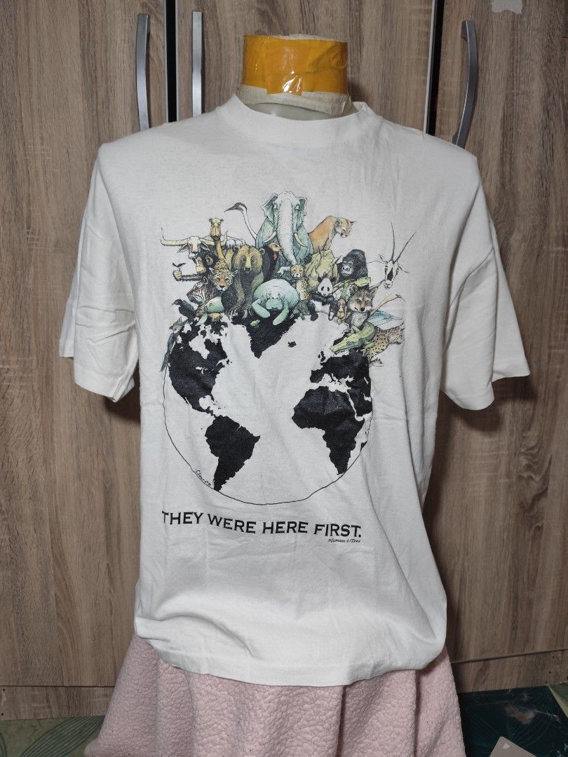 Vintage Animal Tee, Human I tees (Category: Tshirts & Polo Shirts ) located in Cebu City. Submitted by icoolectnsellect (Listing ID 1468674498, Image 1). Description: - Brand: Reflections Organic - Size: L (100% Certified Organic Cotton) - Design: 'They Were Here First' earth and animal graphic with 'Cliner 92' signature - Color: White - Measurements: 23.5" (width) x 27.8" (length) - Condition: Great pre-loved condition.