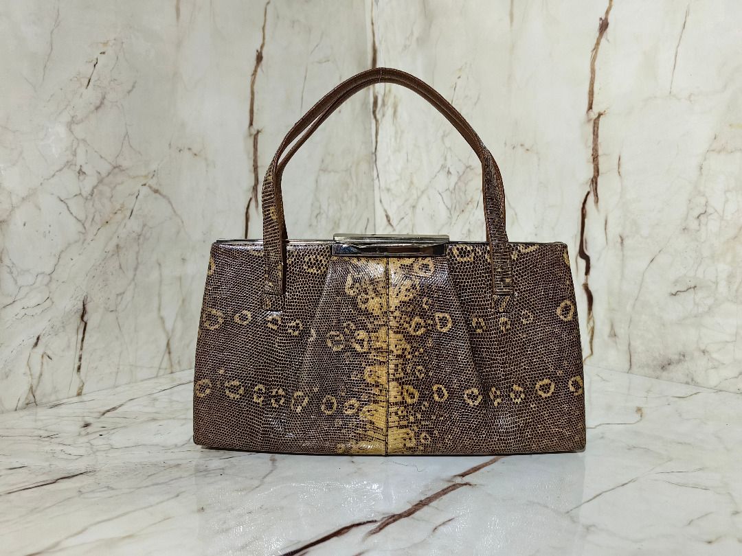 Vintage Brown Lizard Leather handbag with handles (Category: Shoulder Bags) located in Tarlac. Submitted by jeremiah.curator.2026 (Listing ID 1468646653, Image 1). Description: - Stylish brown handbag with a trendy lizard skin leather - Structured design featuring a secure metallic top closure - Equipped with two sturdy top handles for easy carrying - Neat, clean lining with smooth stitching throughout - Compact size, ideal for your everyday esse