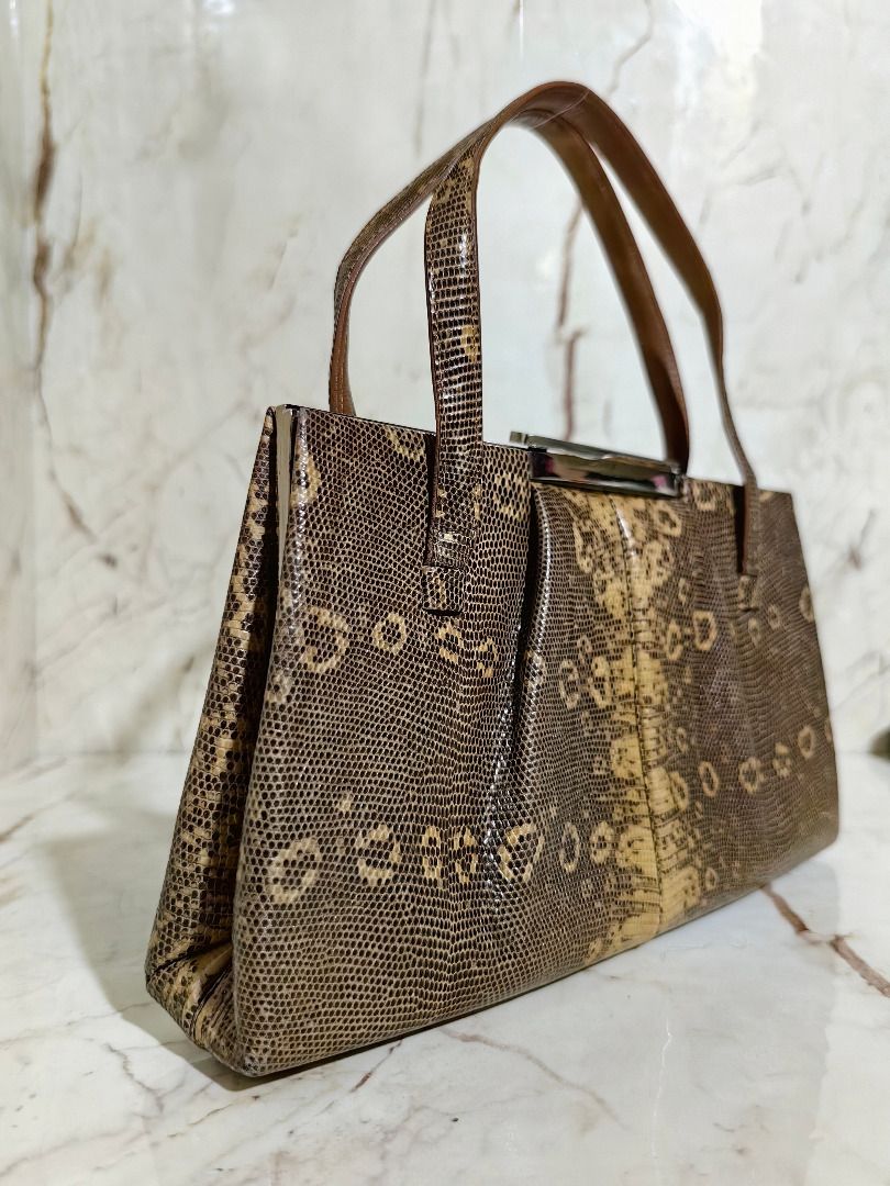 Vintage Brown Lizard Leather handbag with handles (Category: Shoulder Bags) located in Tarlac. Submitted by jeremiah.curator.2026 (Listing ID 1468646653, Image 3). Description: - Stylish brown handbag with a trendy lizard skin leather - Structured design featuring a secure metallic top closure - Equipped with two sturdy top handles for easy carrying - Neat, clean lining with smooth stitching throughout - Compact size, ideal for your everyday esse
