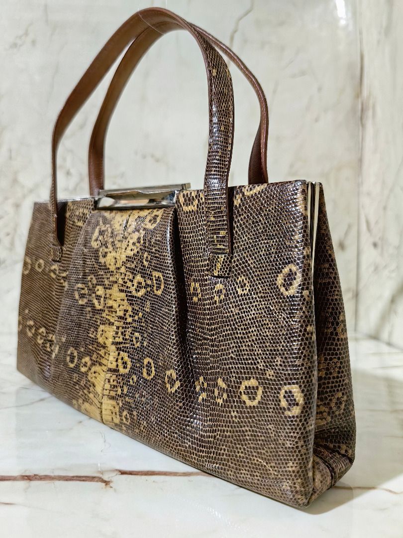 Vintage Brown Lizard Leather handbag with handles (Category: Shoulder Bags) located in Tarlac. Submitted by jeremiah.curator.2026 (Listing ID 1468646653, Image 2). Description: - Stylish brown handbag with a trendy lizard skin leather - Structured design featuring a secure metallic top closure - Equipped with two sturdy top handles for easy carrying - Neat, clean lining with smooth stitching throughout - Compact size, ideal for your everyday esse