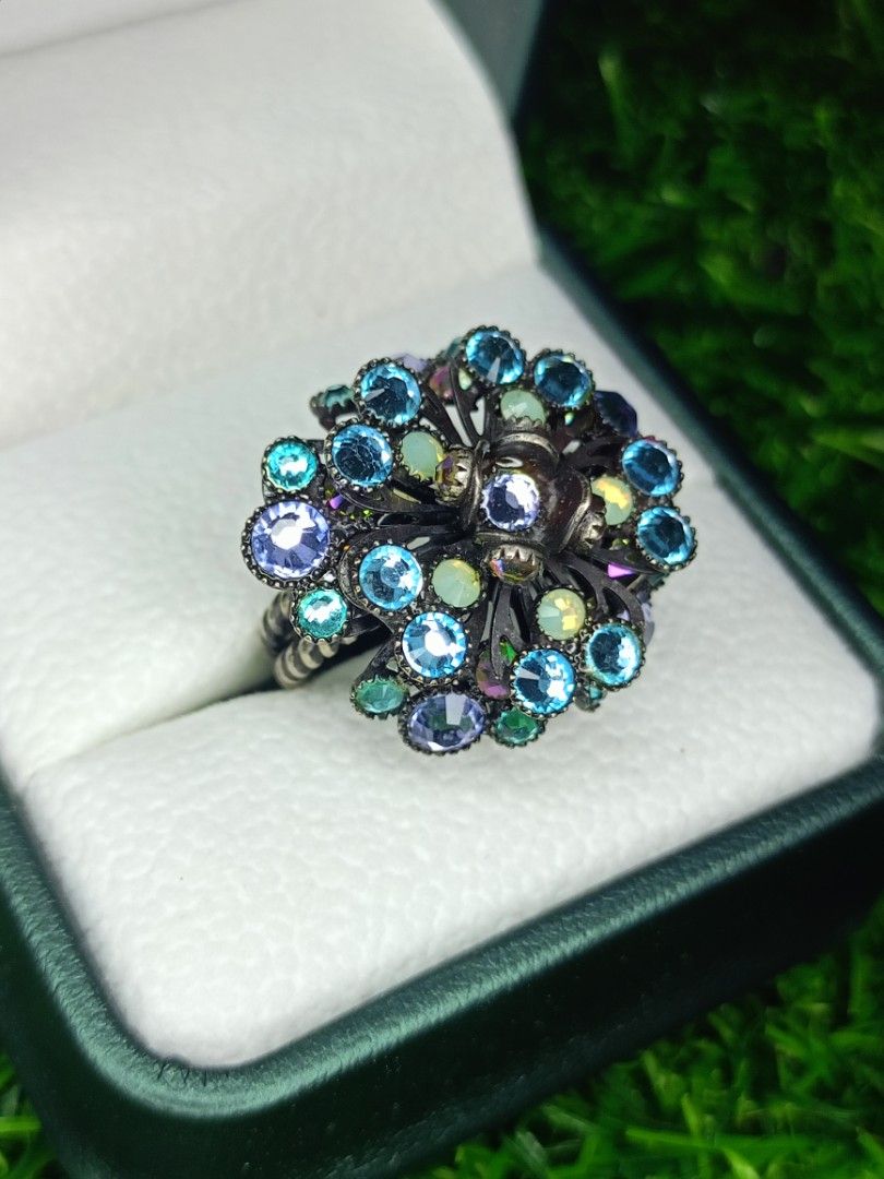 Vintage Flower Rhinestone Adjustable Statement Ring Blue Purple (Category: Rings) located in Bacoor. Submitted by bibelot03 (Listing ID 1468513333, Image 2). Description: - Ornate floral ring with a dark metal finish - Sparkly blue, purple, and pale opalescent rhinestones - Intricate openwork metal setting underneath - Adjustable double-band shank for a comfortable fit - Eye-catching statement piece that shines beautifully in the light.