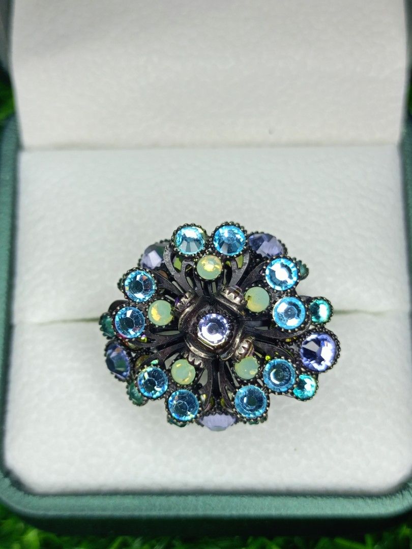 Vintage Flower Rhinestone Adjustable Statement Ring Blue Purple (Category: Rings) located in Bacoor. Submitted by bibelot03 (Listing ID 1468513333, Image 1). Description: - Ornate floral ring with a dark metal finish - Sparkly blue, purple, and pale opalescent rhinestones - Intricate openwork metal setting underneath - Adjustable double-band shank for a comfortable fit - Eye-catching statement piece that shines beautifully in the light.