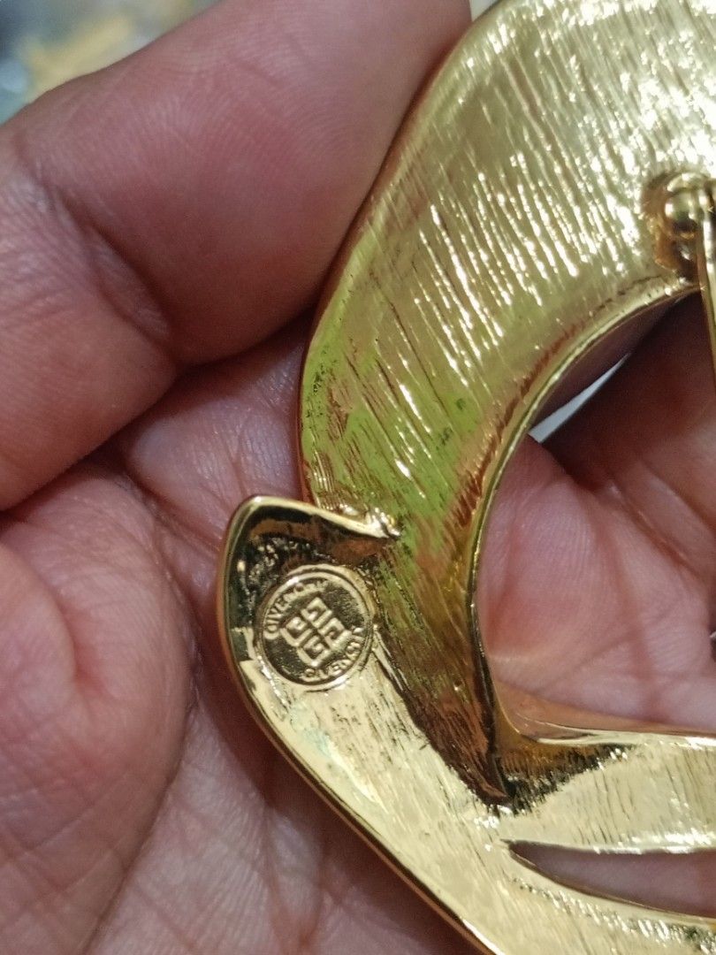 Vintage Givenchy Gold Tone Abstract Statement Brooch (Category: Brooches) located in Bacoor. Submitted by bibelot03 (Listing ID 1468518612, Image 3). Description: - Authentic vintage Givenchy statement brooch - Finish: Brushed and polished gold tone - Design: Unique abstract sculptural loop - Features: Secure pin closure and stamped 4G logo maker's mark on the back - Size/Weight: Solid size with a nice, premium weight - Styling: Great for pinning