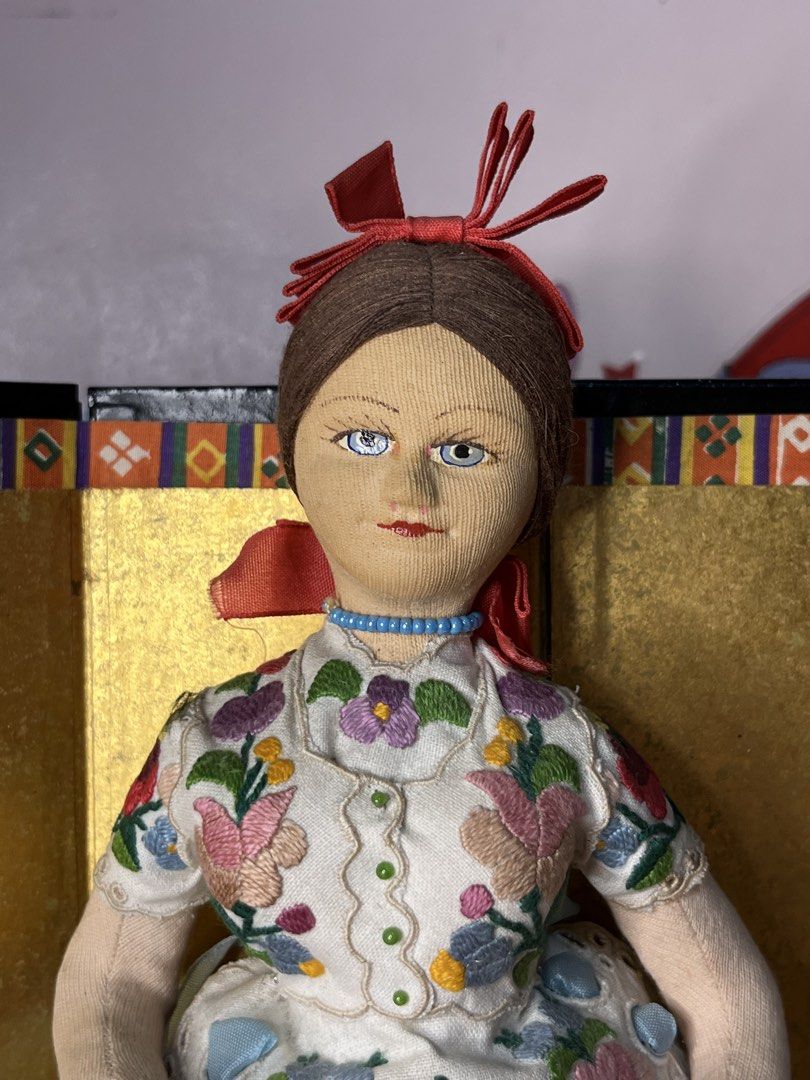 Vintage Hungarian folk art doll (Category: Plushies & Soft Toys) located in Gapan. Submitted by lunashop14 (Listing ID 1468689140, Image 2). Description: Vintage Hungarian Folk Art Cloth Doll – Hand-Painted Face & Kalocsa Embroidery Description: Up for sale is a beautiful vintage Hungarian folk art souvenir doll. This stunning collectible features a molded cloth face with hand-painted blue eyes and fine facial details. She wears an authentic, hig
