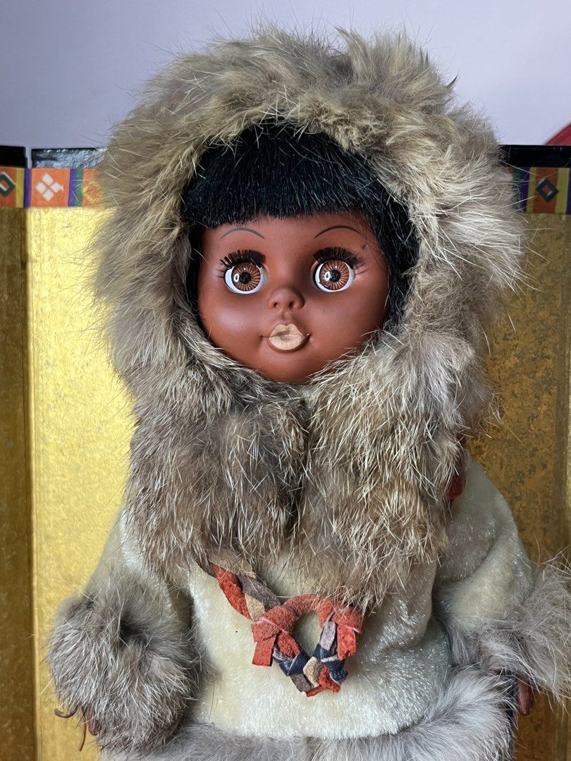 Vintage Inuit Eskimo Doll with Fur clothes (Category: Plushies & Soft Toys) located in Gapan. Submitted by lunashop14 (Listing ID 1468688321, Image 2). Description: - Vintage Inuit-style doll featuring a dark complexion and expressive brown eyes - Dressed in a thick, stylish fur-trimmed parka with a cozy matching hood - Accented with a braided leather necklace and carrying a small pouch or tool accessory - Fitted with detailed suede-like mukluks 