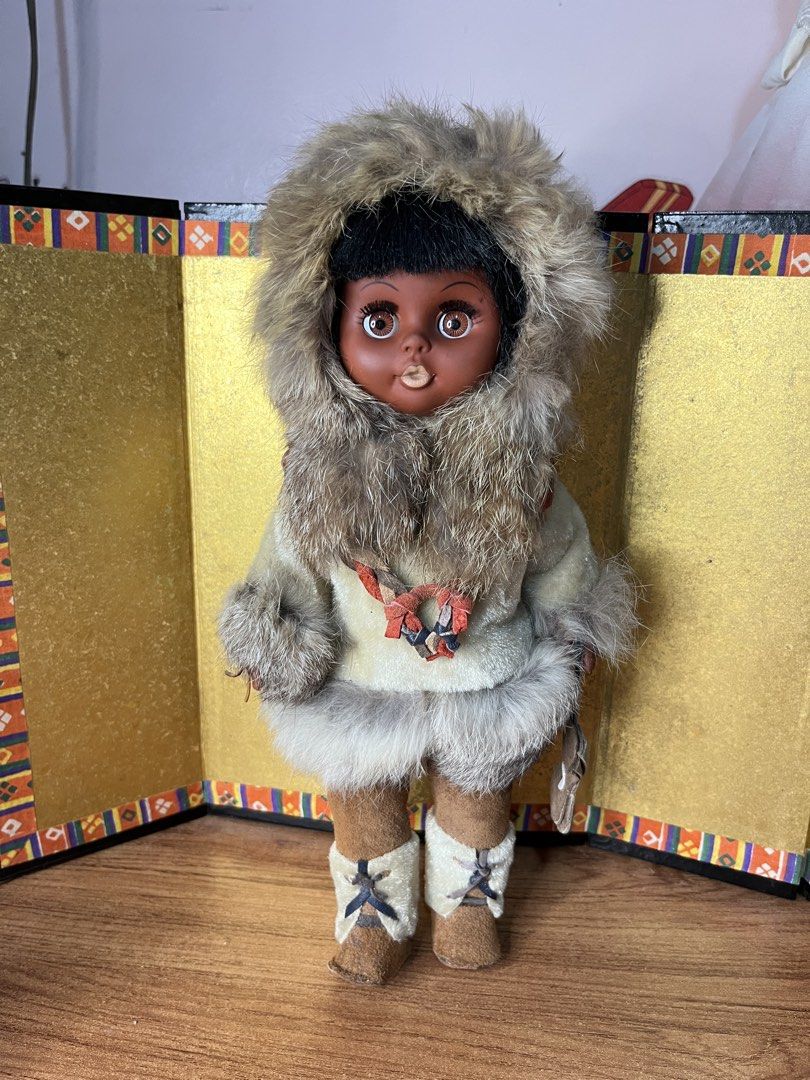 Vintage Inuit Eskimo Doll with Fur clothes (Category: Plushies & Soft Toys) located in Gapan. Submitted by lunashop14 (Listing ID 1468688321, Image 1). Description: - Vintage Inuit-style doll featuring a dark complexion and expressive brown eyes - Dressed in a thick, stylish fur-trimmed parka with a cozy matching hood - Accented with a braided leather necklace and carrying a small pouch or tool accessory - Fitted with detailed suede-like mukluks 