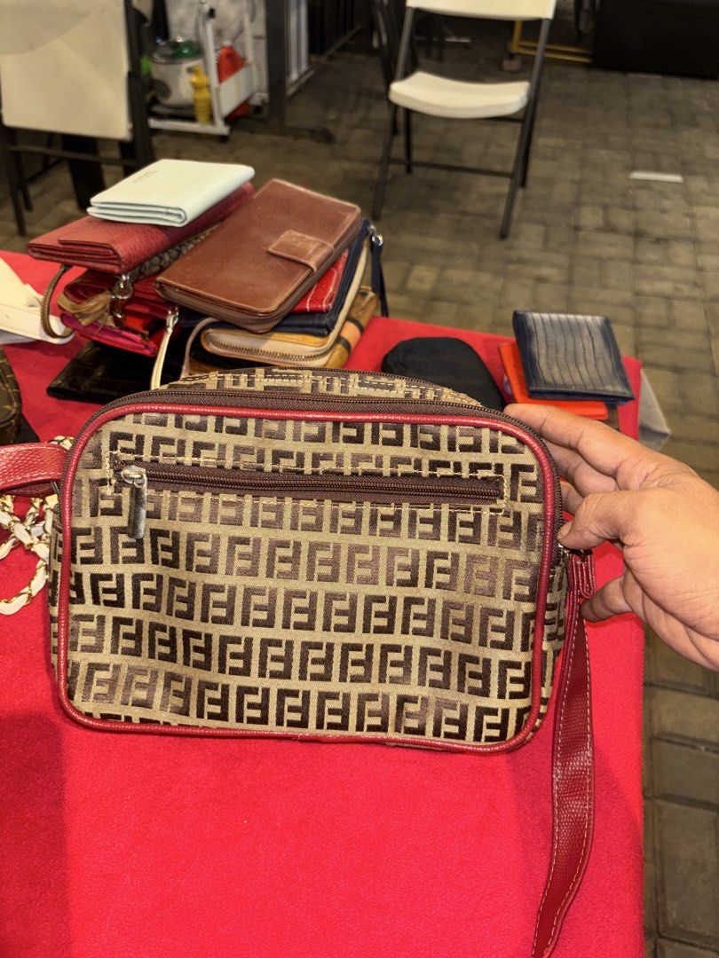 Vintage Monogram Pattern Crossbody Bag with Red Leather Trim (Category: Luxury Bags & Wallets) located in Manila. Submitted by jeromskito66462 (Listing ID 1468667400, Image 3). Description: - Stylish monogram fabric with vibrant red leather trim - Structured rectangular shape with dual zippered compartments - Handy front zip pocket featuring a metal hardware plate - Adjustable red shoulder strap for comfortable wear - Black fabric-lined interior 