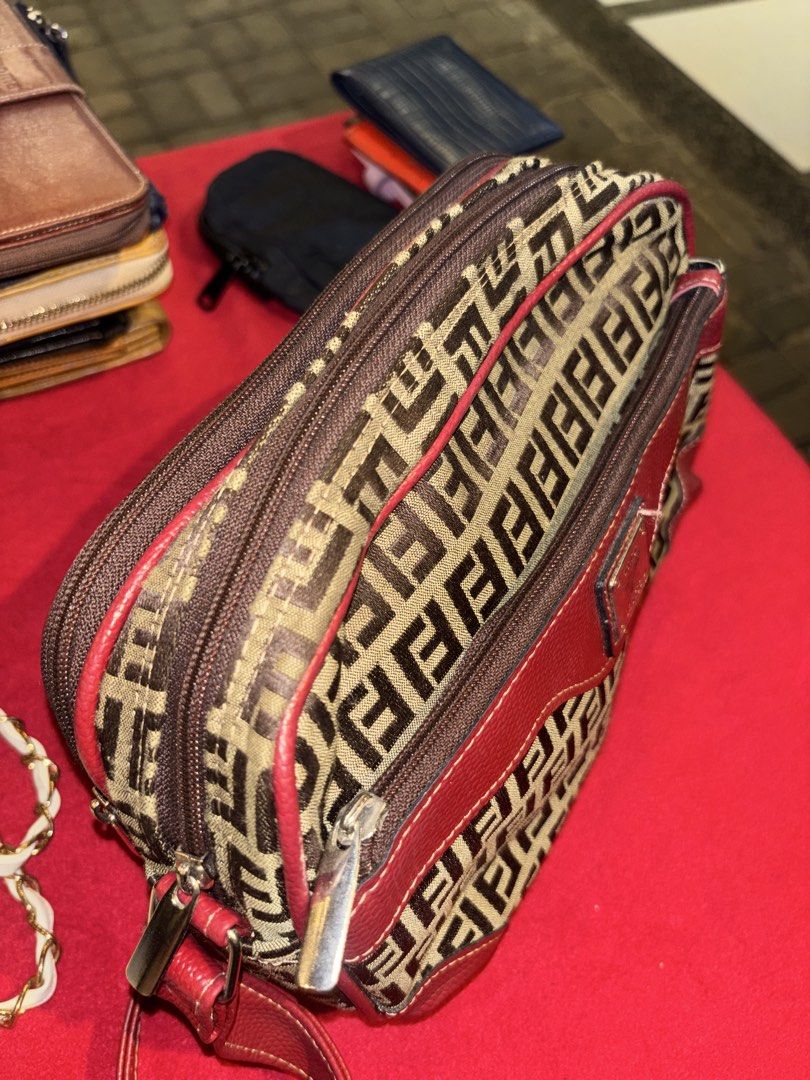 Vintage Monogram Pattern Crossbody Bag with Red Leather Trim (Category: Luxury Bags & Wallets) located in Manila. Submitted by jeromskito66462 (Listing ID 1468667400, Image 2). Description: - Stylish monogram fabric with vibrant red leather trim - Structured rectangular shape with dual zippered compartments - Handy front zip pocket featuring a metal hardware plate - Adjustable red shoulder strap for comfortable wear - Black fabric-lined interior 