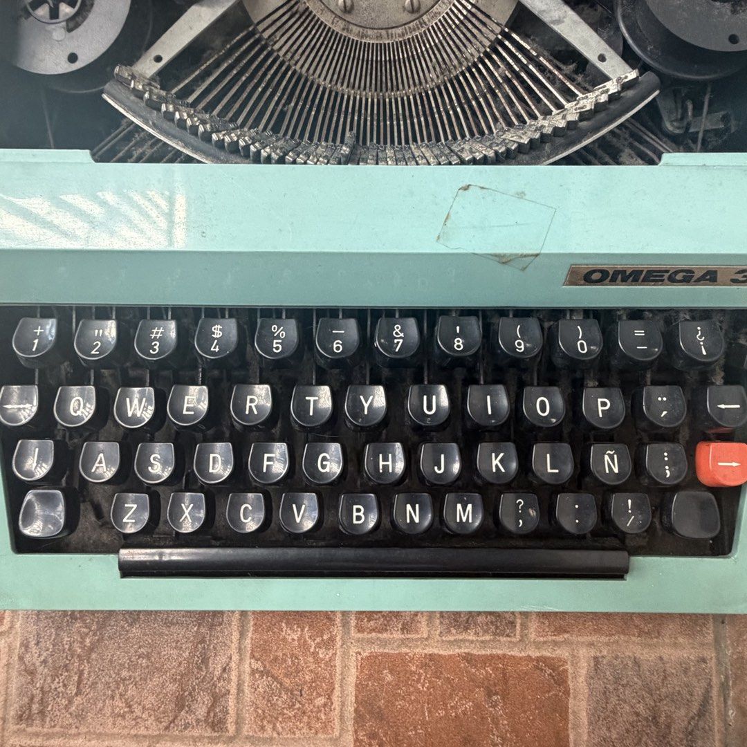 Vintage OMEGA 30 Typewriter (Category: Office & Business Technology) located in Quezon City. Submitted by stardewwitcher (Listing ID 1468588880, Image 3). Description: Vintage OMEGA 30 Typewriter – ₱3,000 (Negotiable) Selling a vintage OMEGA 30 typewriter for ₱3,000, negotiable! Details: * Vintage OMEGA 30 typewriter * Unique mint green/turquoise body with classic black keys * Spanish keyboard layout, including the Ñ key * Great as a vintage coll