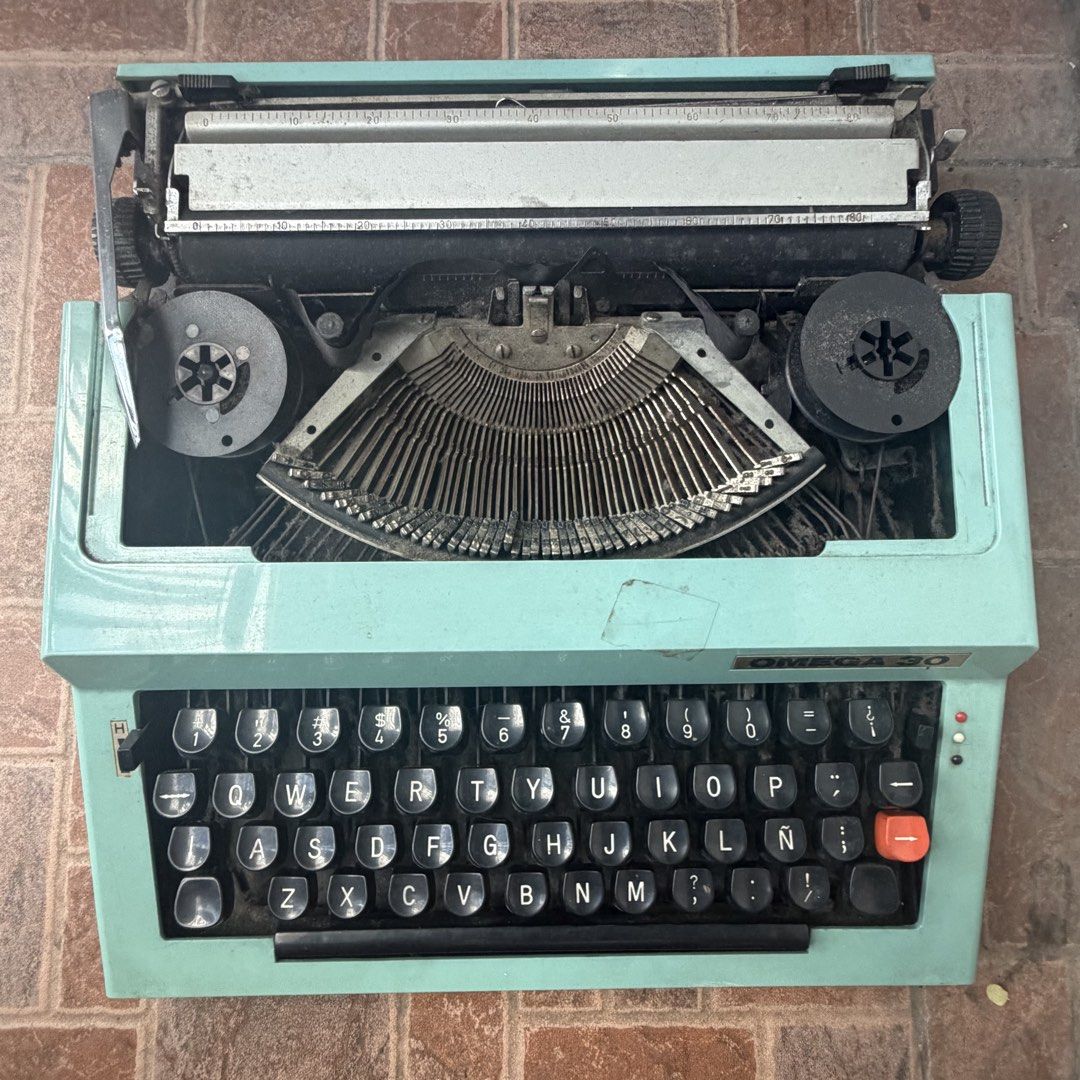 Vintage OMEGA 30 Typewriter (Category: Office & Business Technology) located in Quezon City. Submitted by stardewwitcher (Listing ID 1468588880, Image 1). Description: Vintage OMEGA 30 Typewriter – ₱3,000 (Negotiable) Selling a vintage OMEGA 30 typewriter for ₱3,000, negotiable! Details: * Vintage OMEGA 30 typewriter * Unique mint green/turquoise body with classic black keys * Spanish keyboard layout, including the Ñ key * Great as a vintage coll