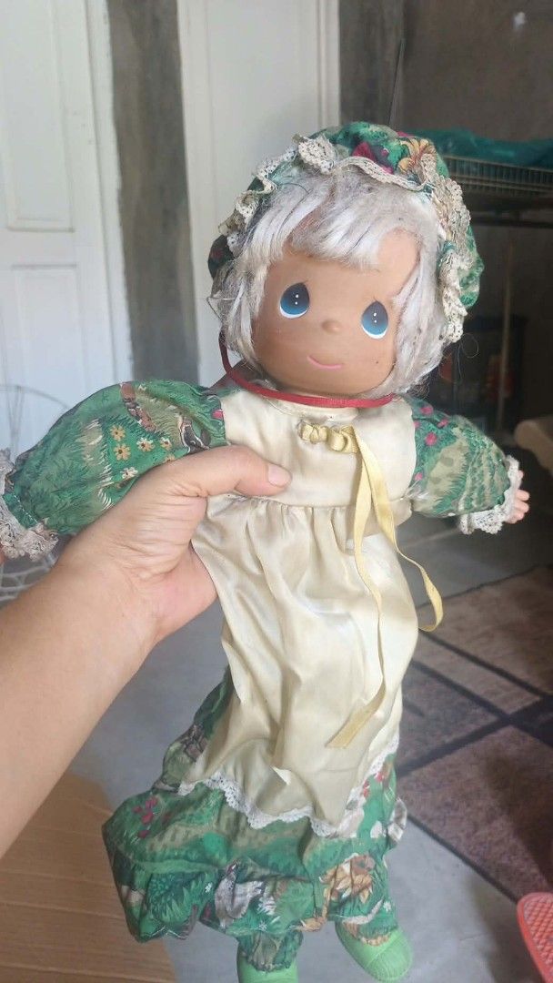 Vintage Precious Moments rag doll (Category: Plushies & Soft Toys) located in Mandaluyong City. Submitted by LEATHERFACE (Listing ID 1468549390, Image 1). Description: - Authentic Precious Moments soft-body collector doll - Features signature teardrop-shaped eyes and painted facial details - Dressed in a charming green and white floral dress, matching bonnet, and white pinafore overlay - Fabric clothing is well-preserved and completely intact - S