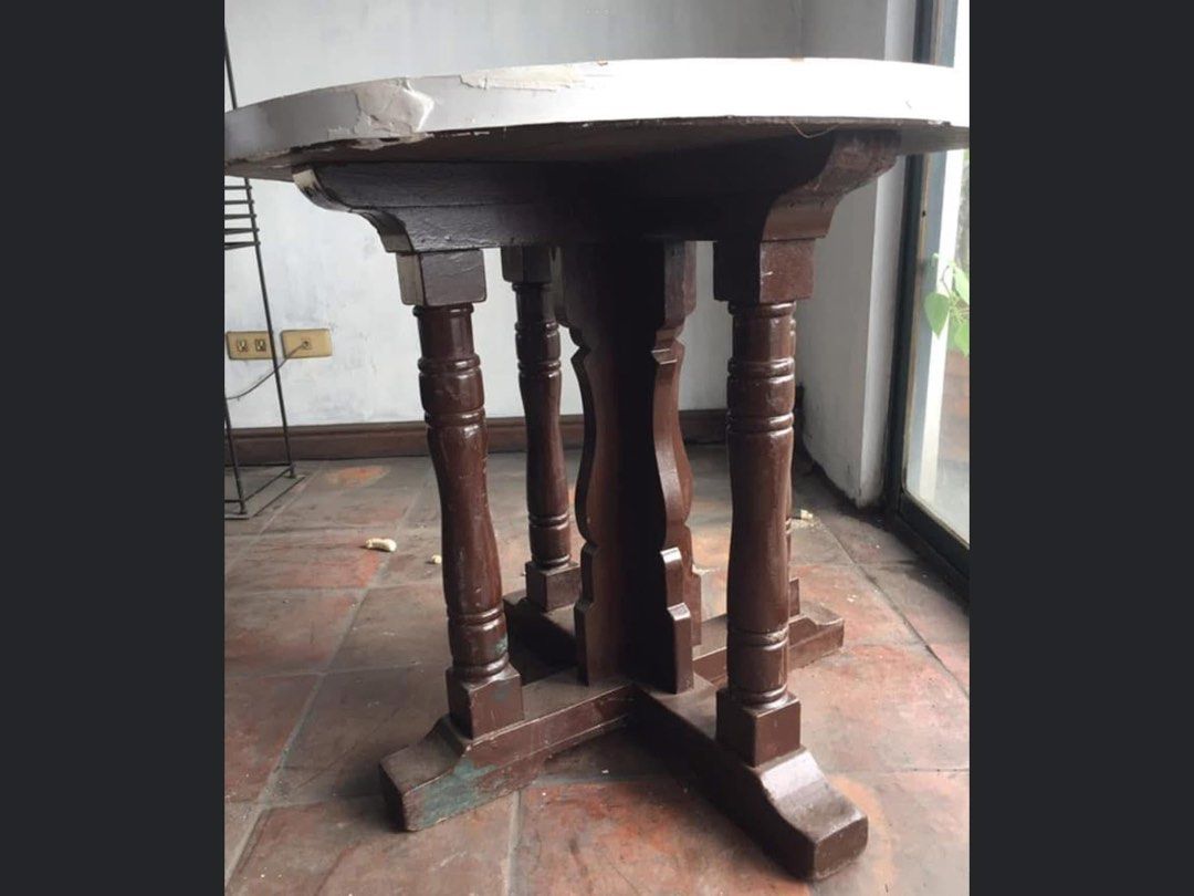 Vintage Round Wooden Dining Table with White Top (Category: Tables & Sets) located in Manila. Submitted by roberto.enriquez (Listing ID 1468690236, Image 2). Description: - Type: Round wooden dining table - Base: Dark brown carved pedestal with four supporting legs - Tabletop: White painted finish with noticeable surface scratches and scuffs - Condition: Sturdy solid wood build, shows visible wear from previous use - Ideal For: DIY repainting or 