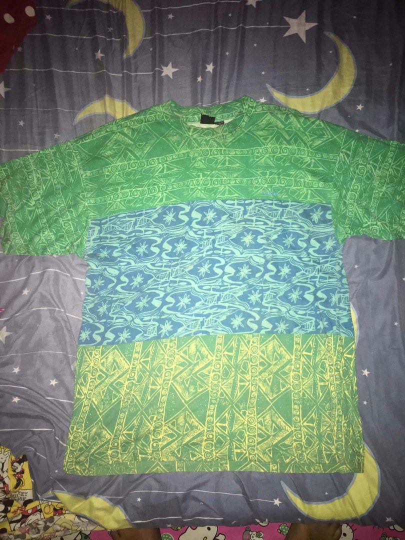 Vintage T&C Surf Designs Block Pattern T-Shirt (Category: Tshirts & Polo Shirts ) located in Gapan. Submitted by friendlyneighborhoodspiderman (Listing ID 1468521543, Image 2). Description: - Brand: Town & Country Surf Designs - Design: Three horizontal color-blocked panels (green, blue, yellow) with abstract tribal and wave prints - Material: 100% breathable cotton with woven neck tags - Fit/Style: Short sleeves, crew neck, classic vintage skate