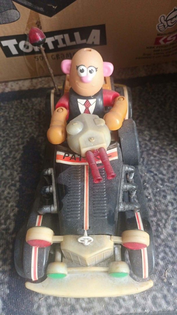 Vintage Toy Car with Figure (Category: Vehicle & Diecast Models) located in Mandaluyong City. Submitted by LEATHERFACE (Listing ID 1468552474, Image 1). Description: - Retro black toy car featuring a bald driver figure - Equipped with dual front red cannons and a red-tipped antenna - Sporty white and red striping along the fenders - Made of durable plastic with minor signs of age and play - Perfect collectible item for display or retro toy enthus