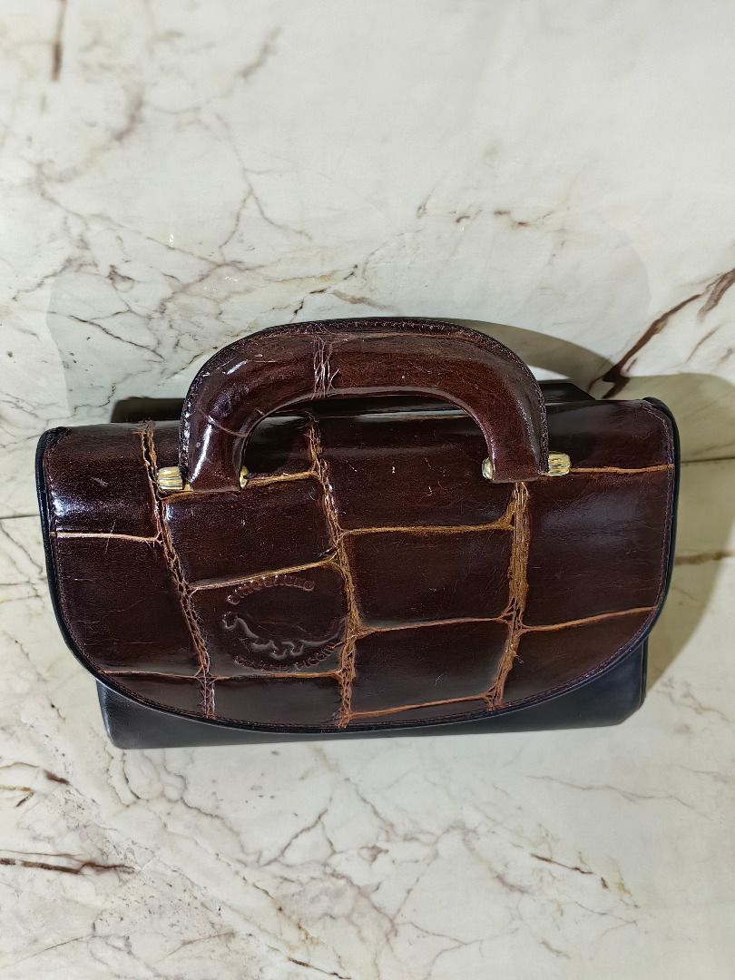 Vintage Two-Tone Crocodile Pattern Structured Handbag ion (Category: Luxury Bags & Wallets) located in Tarlac. Submitted by jeremiah.curator.2026 (Listing ID 1468663849, Image 2). Description: - Vintage structured handbag in a chic brown and black colorway - Glossy crocodile-embossed flap top paired with a smooth black leather base - Elegant top handle accented with gold-tone hardware - Convenient exterior zippered pocket on the back - Protective