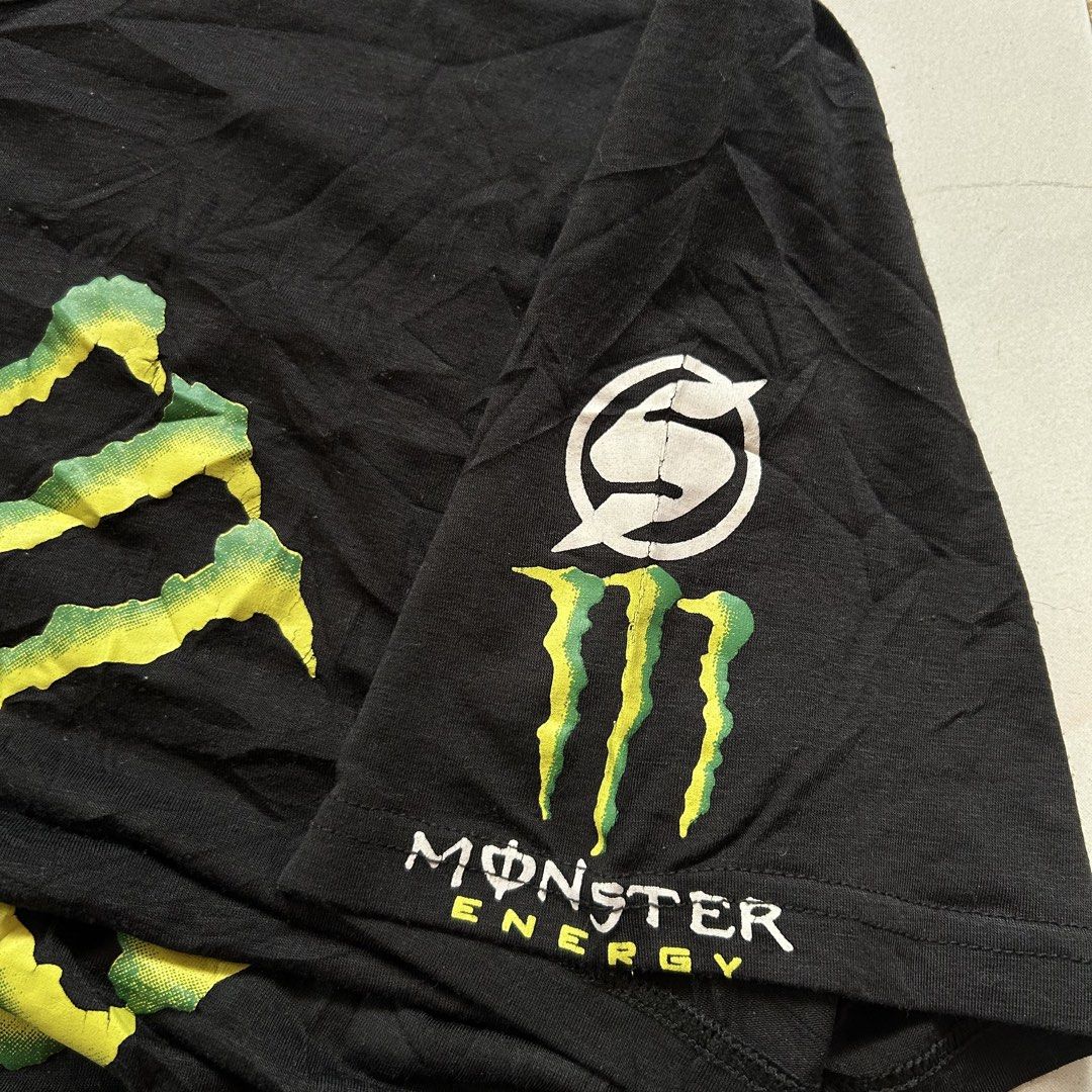Volcom x Monster Energy shirt 🔥 (Category: Activewear) located in Jinoba-an. Submitted by eegiboy (Listing ID 1468533949, Image 3). Description: - Brand: Volcom x Monster Energy Collaboration - Item: Short Sleeve Graphic Tee - Color: Black - Size: L (Large) - Design: Large green claw marks with Volcom stone logo and Monster Energy branding on front; small graphic on left sleeve - Condition: Minor wear and slight wrinkling from storage, overall s