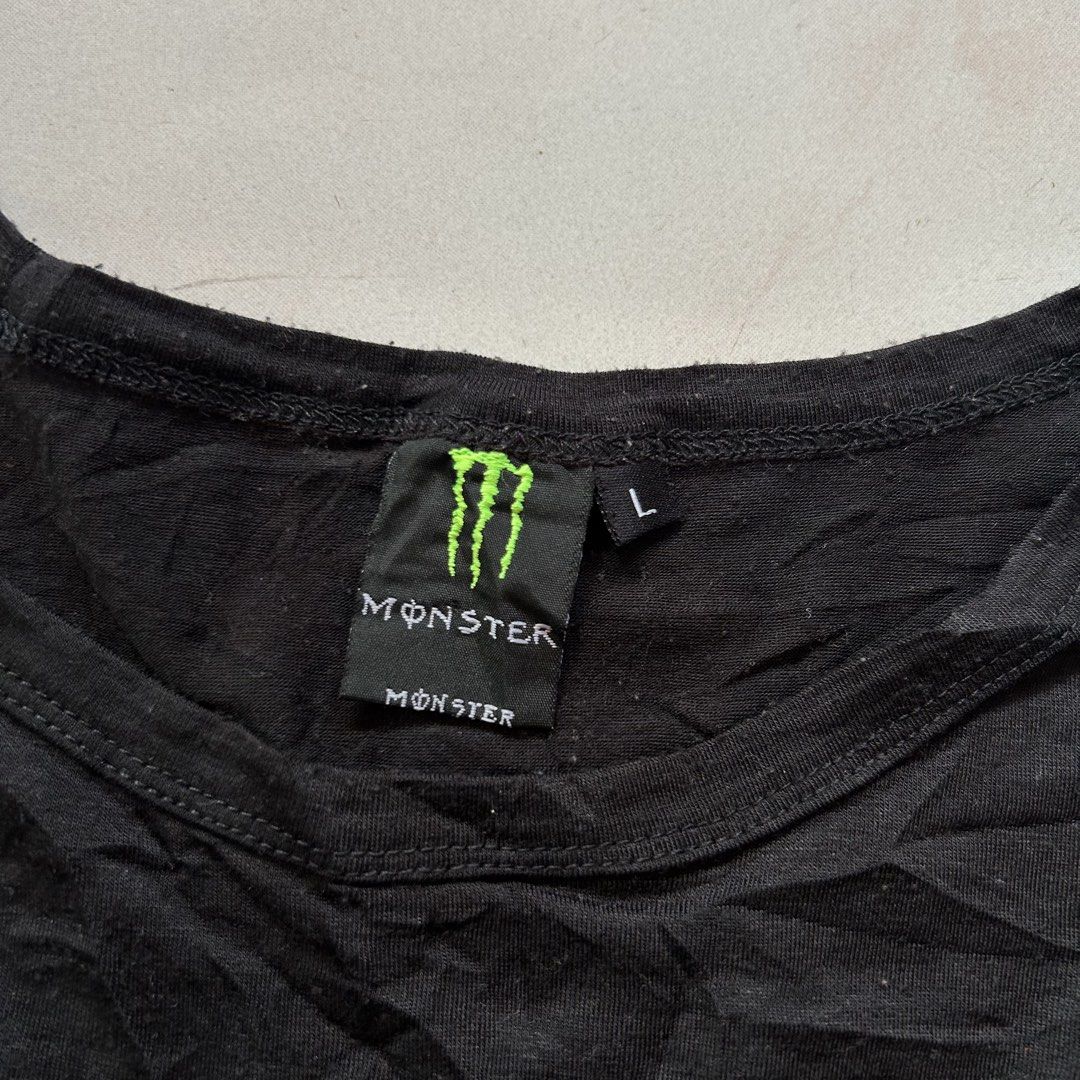 Volcom x Monster Energy shirt 🔥 (Category: Activewear) located in Jinoba-an. Submitted by eegiboy (Listing ID 1468533949, Image 2). Description: - Brand: Volcom x Monster Energy Collaboration - Item: Short Sleeve Graphic Tee - Color: Black - Size: L (Large) - Design: Large green claw marks with Volcom stone logo and Monster Energy branding on front; small graphic on left sleeve - Condition: Minor wear and slight wrinkling from storage, overall s