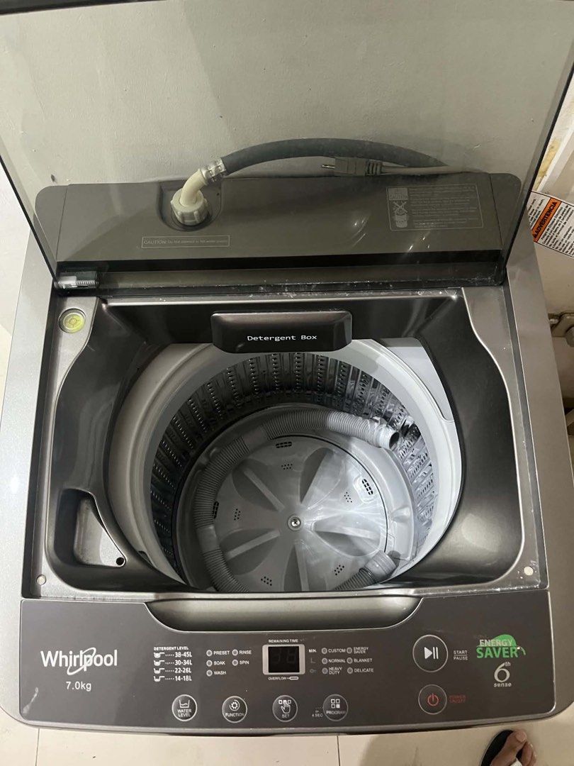 Whirlpool 7.0kg Top Load Fully Auto Washer (Category: Washing Machines and Dryers) located in Taguig. Submitted by swiftearth_250c75 (Listing ID 1468569869, Image 3). Description: Whirlpool top load washing machine with 7kg capacity. Energy saver 6th sense technology built in. Digital display panel with multiple wash programs and water level options. Grey body with transparent dark lid. Includes inlet hose and drain hose inside the drum. Clean un