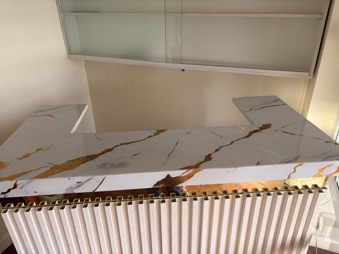 White and Gold Marble Reception Desk with Drawers (Category: Office Furniture & Fixtures) located in Manila. Submitted by jemarie173810 (Listing ID 1468507639, Image 2). Description: - Elegant white reception desk featuring a gold marble-patterned countertop - Stylish slatted front panel design with a built-in glass top workstation area - Ample storage: 3 side drawers with gold knobs and a central locking mechanism for security - Sturdy and solid